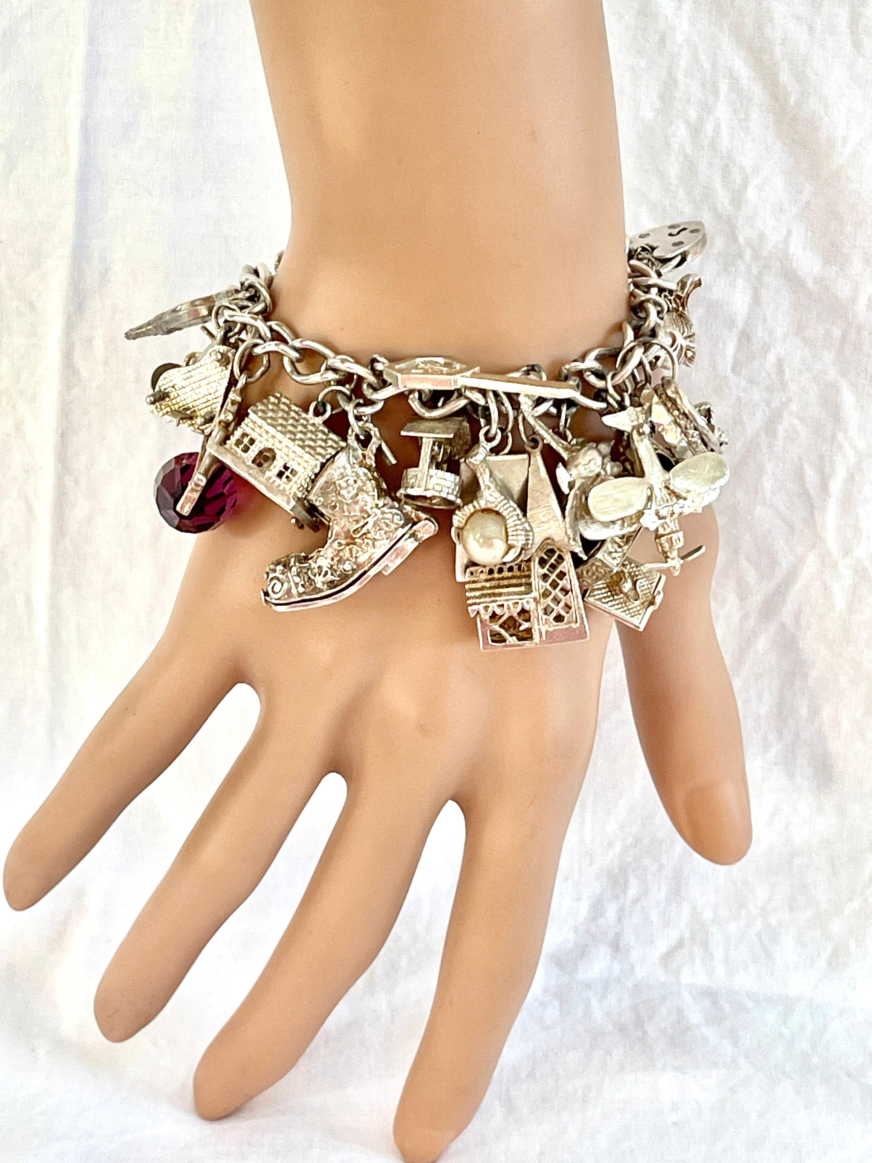 Take a gool look at this beautiful charm bracelet!

It features 28 gorgeous charms of various meanings and stories.  

There’s a delightful boot which opens up to reveal a cheeky little mouse hiding inside!  There’s a little train station with a