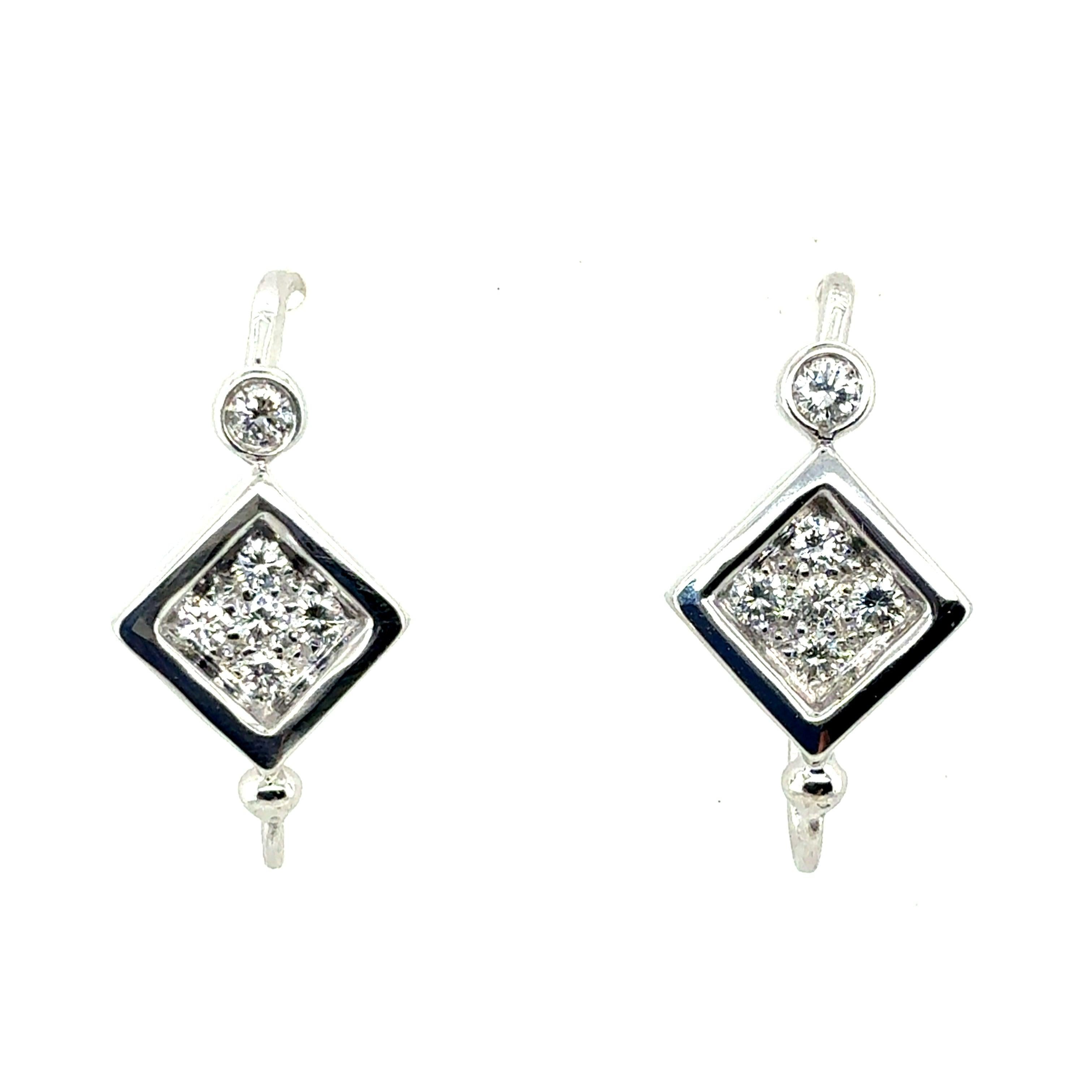 A refined pair of retro earrings crafted in 14k white gold and set with 12 natural colorless diamonds totaling approximately 0.6 carats. The earrings measure approximately 3/4 inch in length and 1/2 inch in width, with a total weight of 6 grams. A
