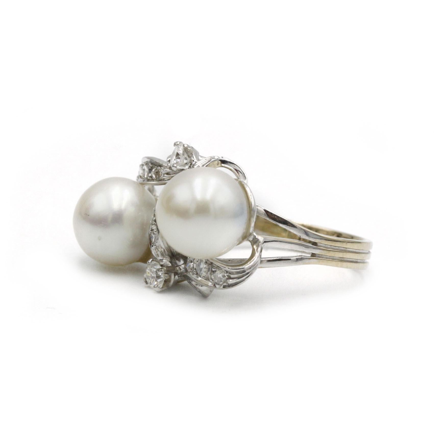 Discover a Retro White Gold Pearl and Diamond Cocktail Ring, a striking mid-20th-century statement piece. Crafted in 18k white gold, this ring showcases two lustrous round pearls entwined in a ribbon-like gallery paved with brilliant-cut diamonds.