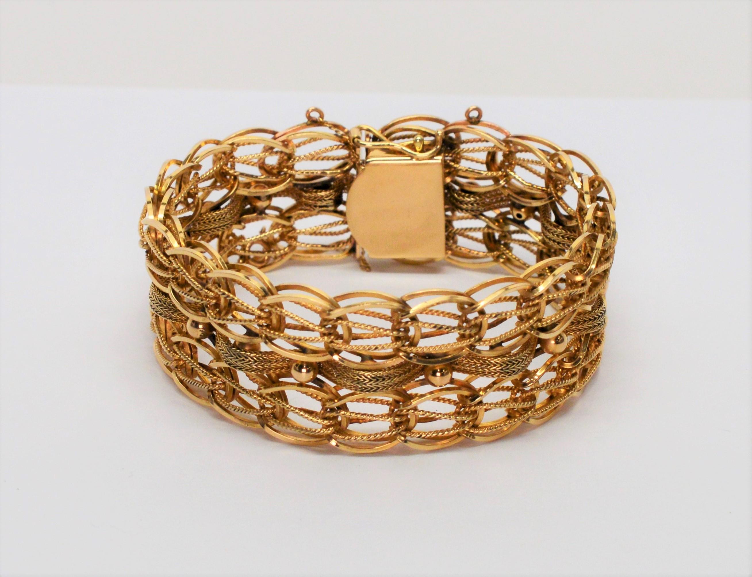 Slender ropes of fourteen karat  14K yellow gold are interwoven within the double links of this fabulous retro bracelet. A ribbon of braided gold runs thru the center and is accented with gold beads to give this intricate bracelet plenty of texture