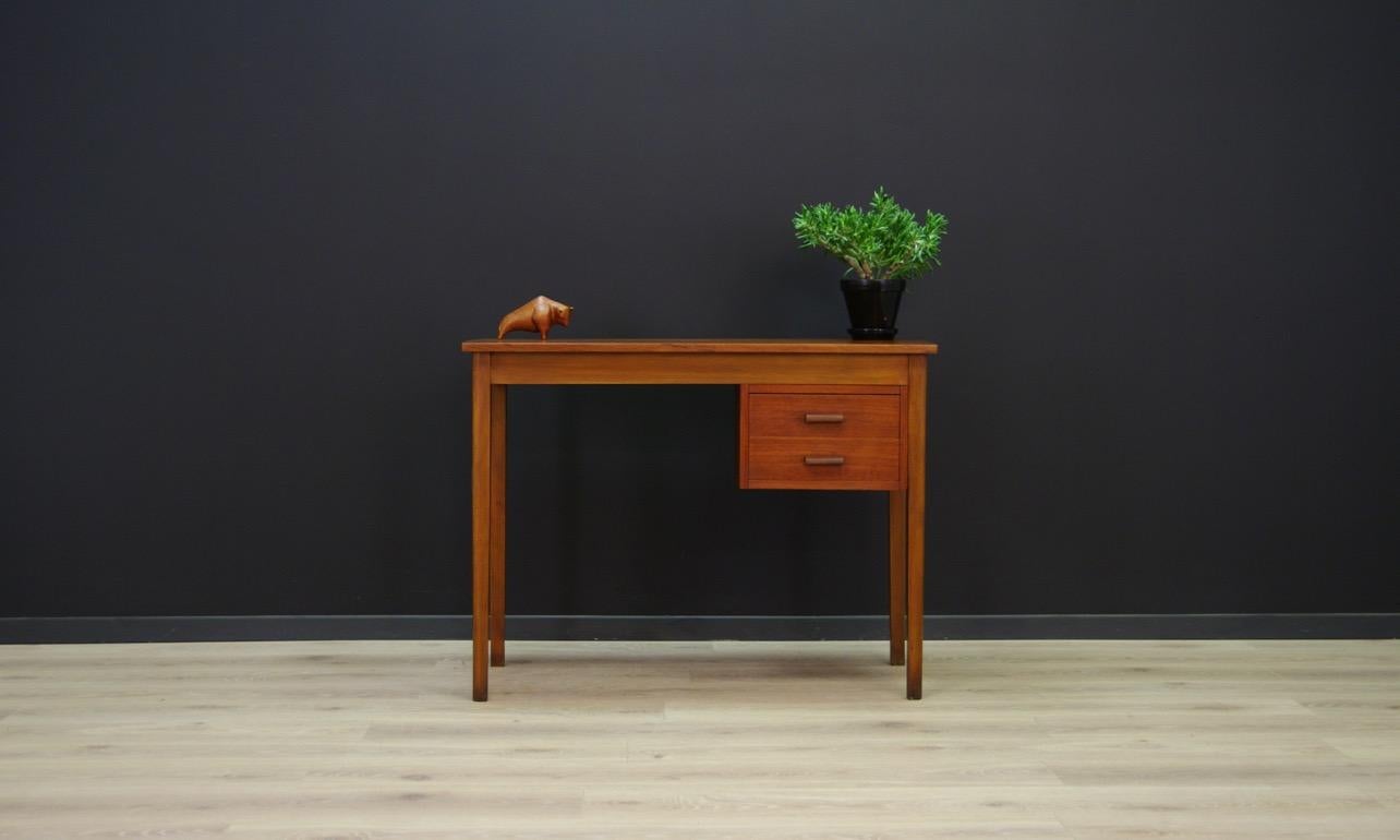 Original desk from the 1960s-1970s, Danish design, Minimalist form. Desk finished with teak veneer. Front with two drawers. Preserved in good condition (small bruises and scratches, filled veneer loss) - directly for use.

Dimensions: height 74