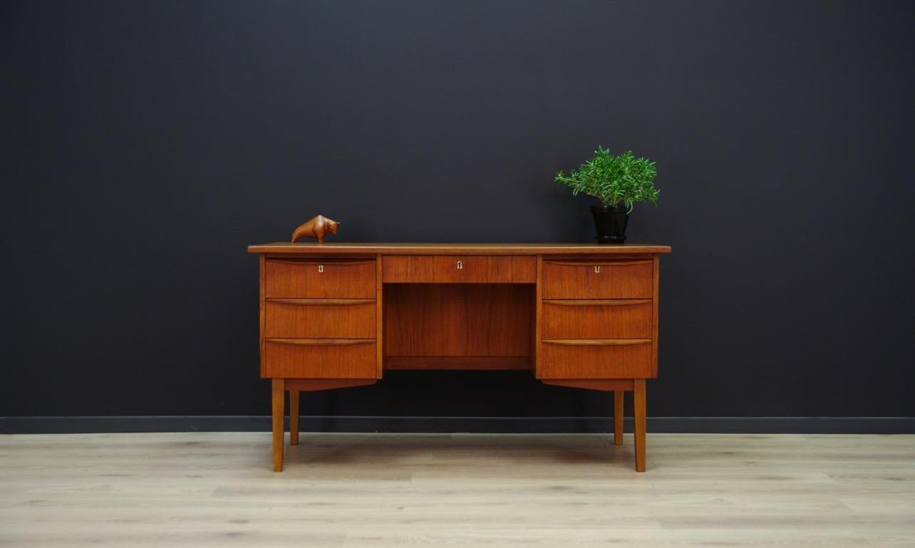 Original desk from the 1960s-1970s, Danish design, Minimalist form finished with teak veneer, handles and legs made of teak wood. Practical front with seven drawers, and book shelf at the back. The key in the set. Preserved in good condition (small