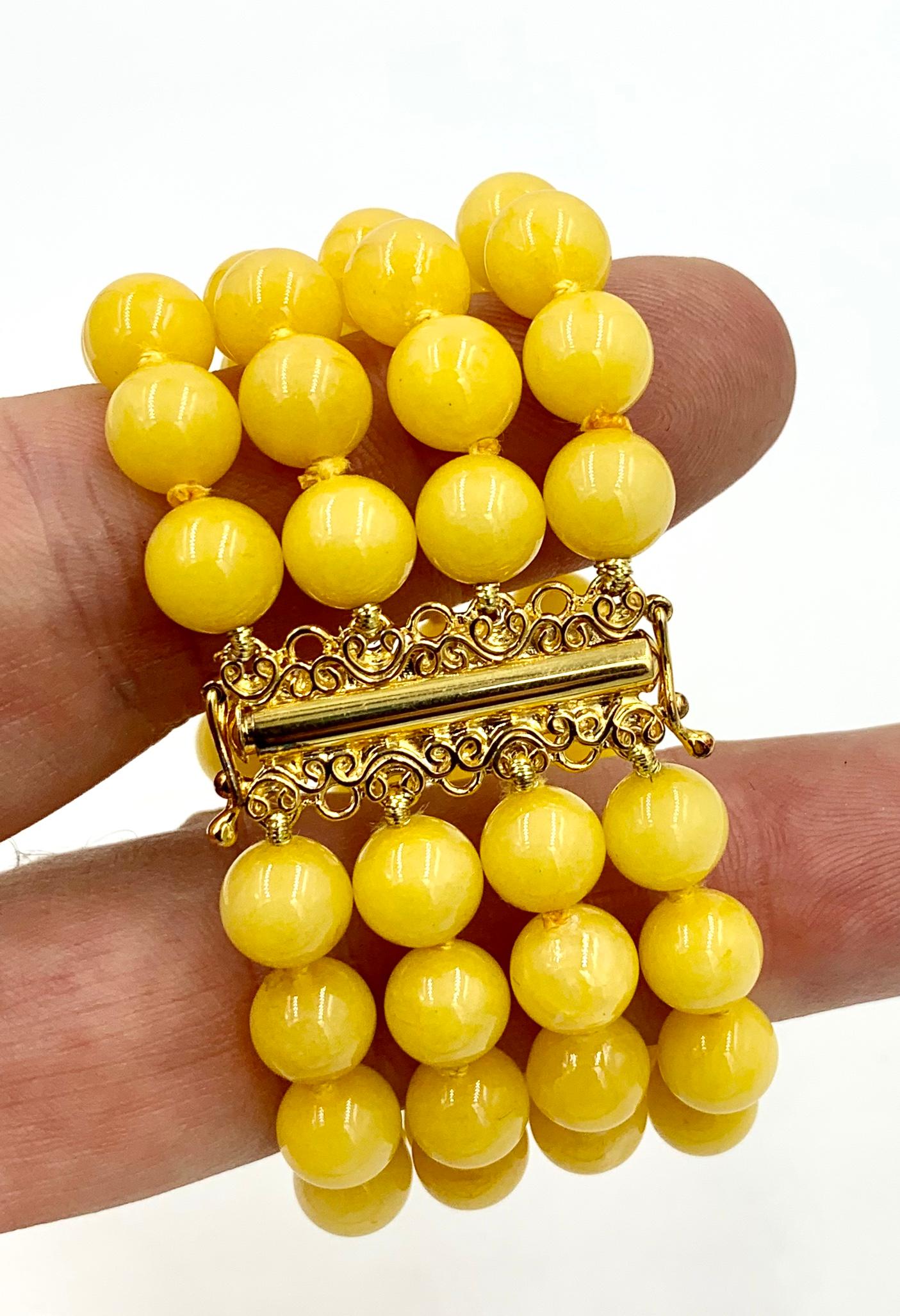 A stunning Yellow Chalcedony Bead Four Strand Bracelet with 9mm wide Chalcedony beads.  The dramatic statement bracelet with the Chalcedony beads in vivid yellow is just fabulous.  The bracelet is 6 inches long and 1 3/8 inches wide.  It has a