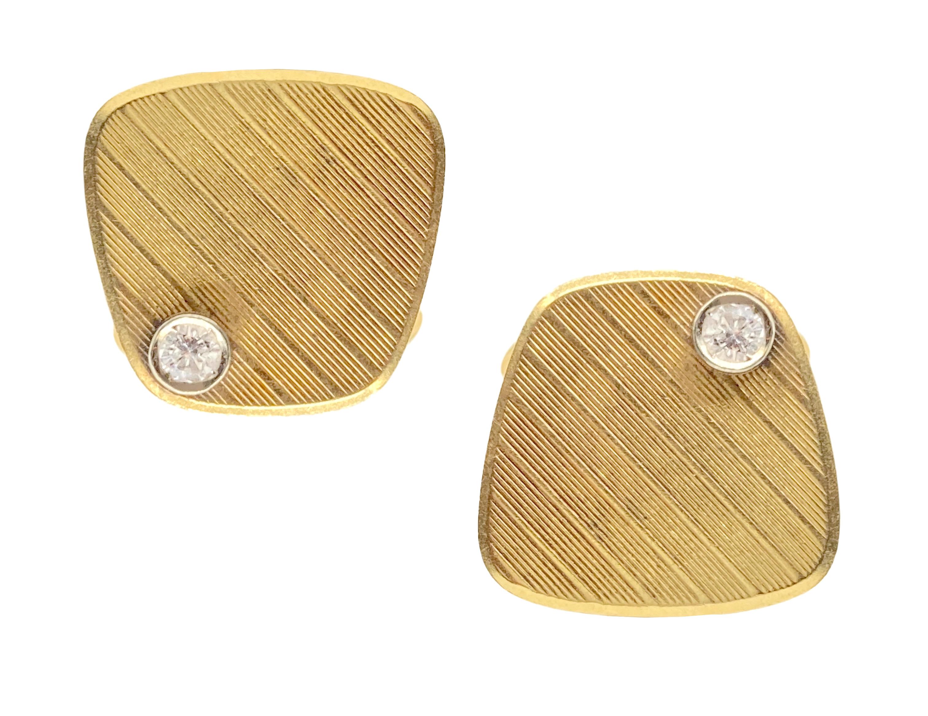 Retro 18 karat yellow gold cufflinks accented by round brilliant cut diamonds. Circa 1950.