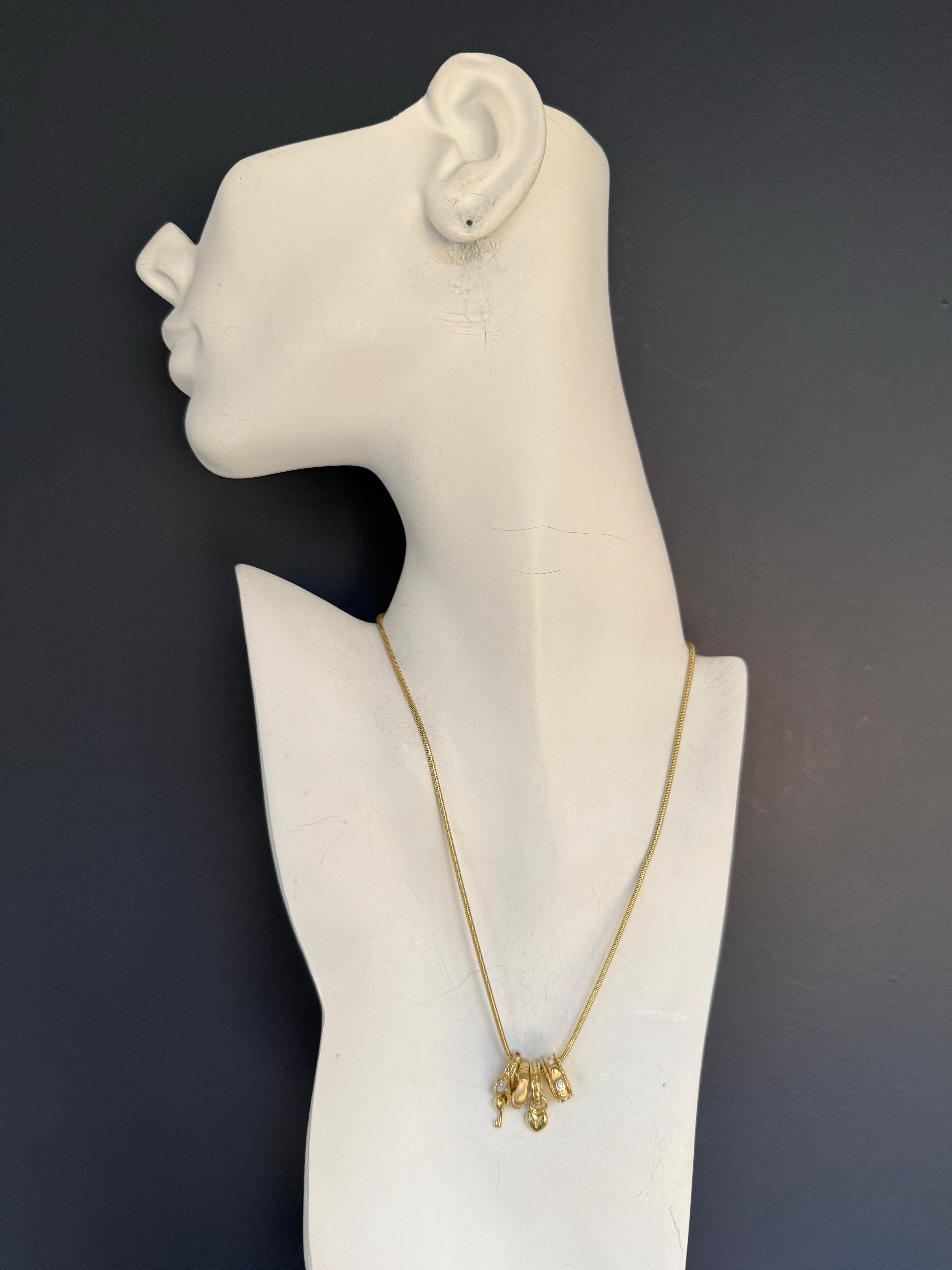 Retro 14K yellow gold chain measuring 16 inches in length and 1.7 mm in thickness, adorned with four designer charms — a diamond charm, an amethyst charm, a ruby charm, and a key-and-heart motif charm. Each charm measures approximately 13 mm in