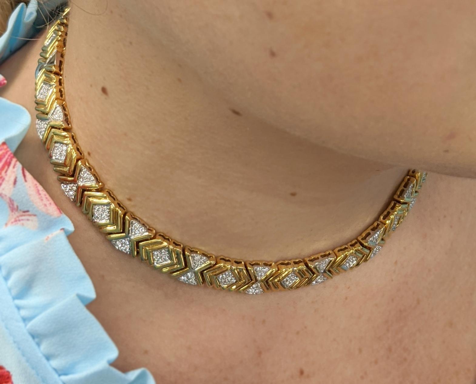 This retro necklace fabricated in 14k yellow gold features geometric links interspersed with round diamonds set atop 14k white god stations.

The necklace contains approximately 110 round cut diamonds having an average color of G and average clarity