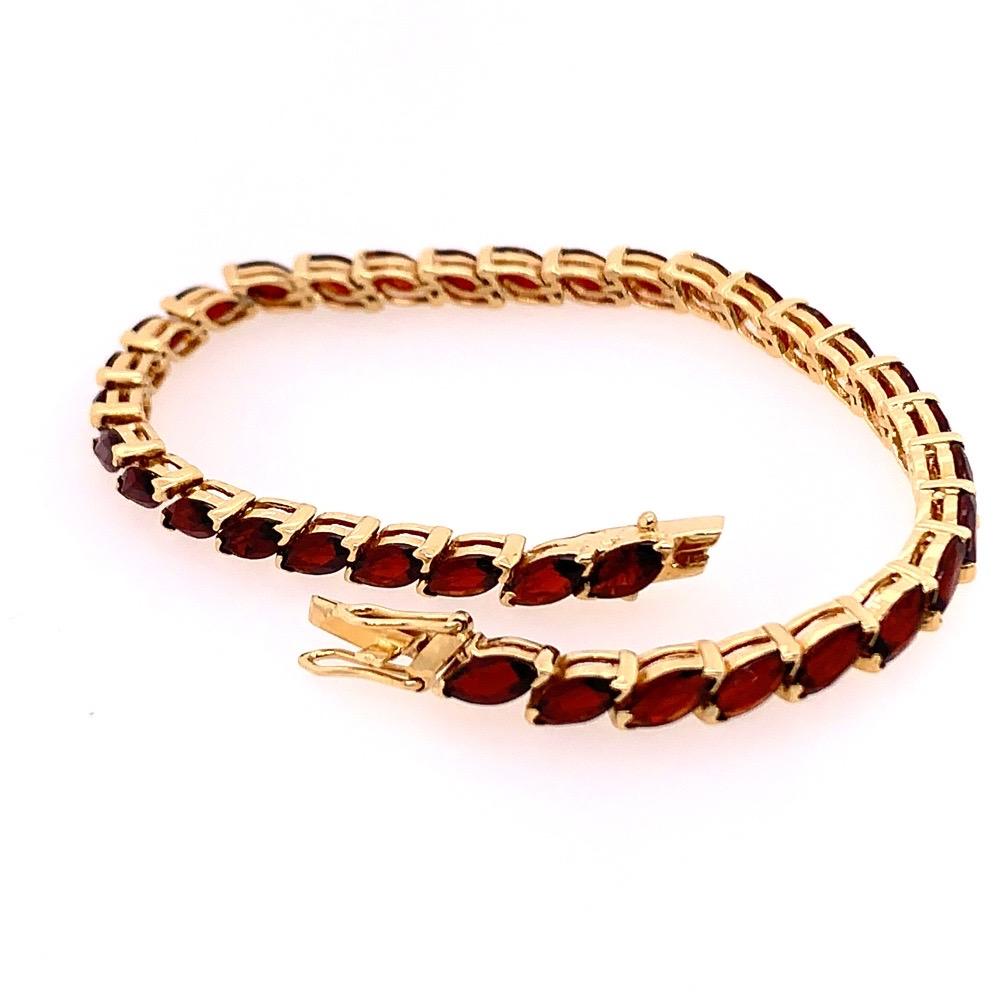 Stunning 14k Yellow Gold Estate Bracelet set with 35 Natural Red Marquise shaped Garnets appx 7x3mm each. 

The color varies depending on lighting, in the range of a brownish RED tone. 

The piece is 6.75