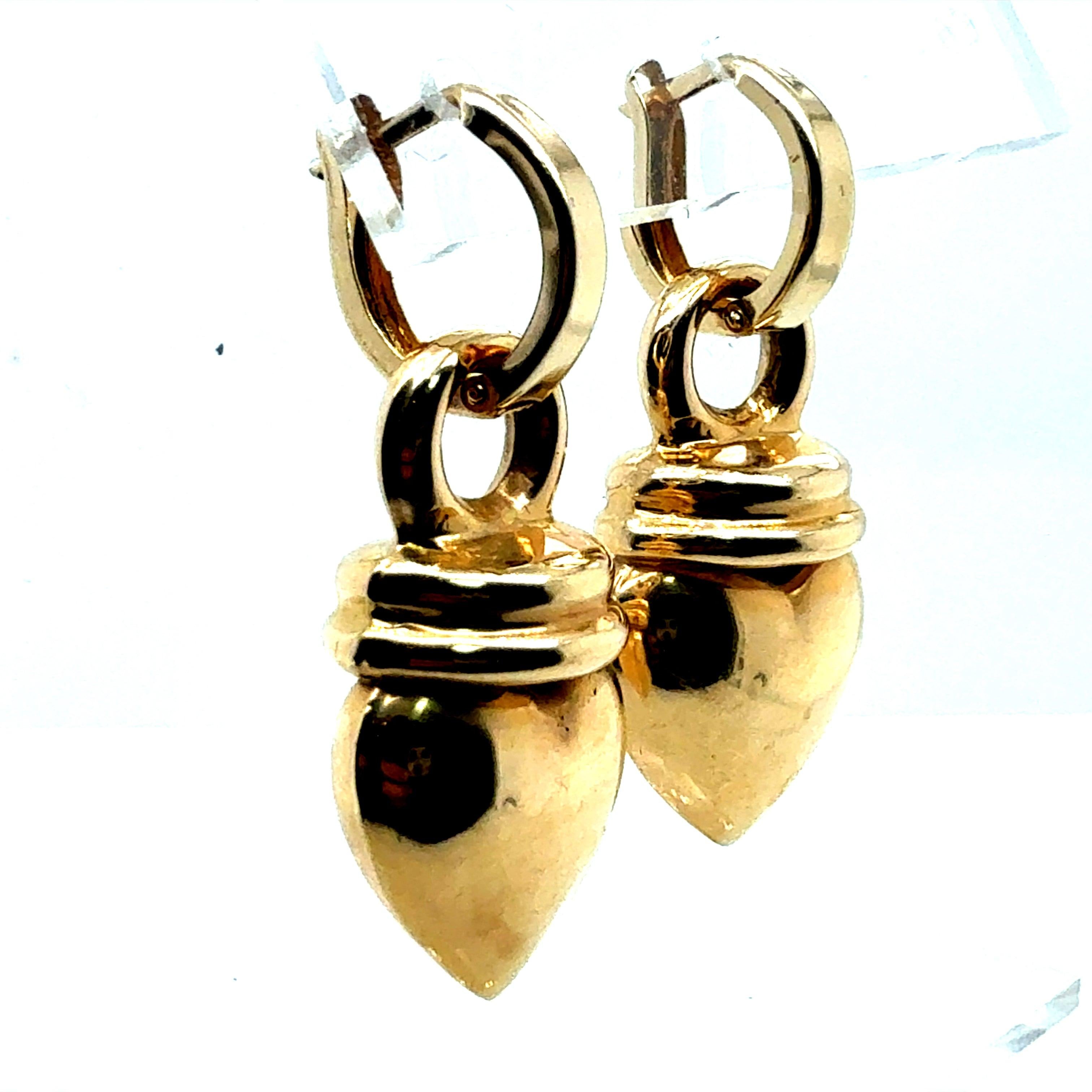 Retro yellow gold heart-shaped drop enhancer earrings measuring approximately 1 inch in length and just over 0.5 inch wide. The drops have a combined weight of 4.5 grams and are suspended from simple 14K yellow gold Huggies weighing 0.6 grams. The