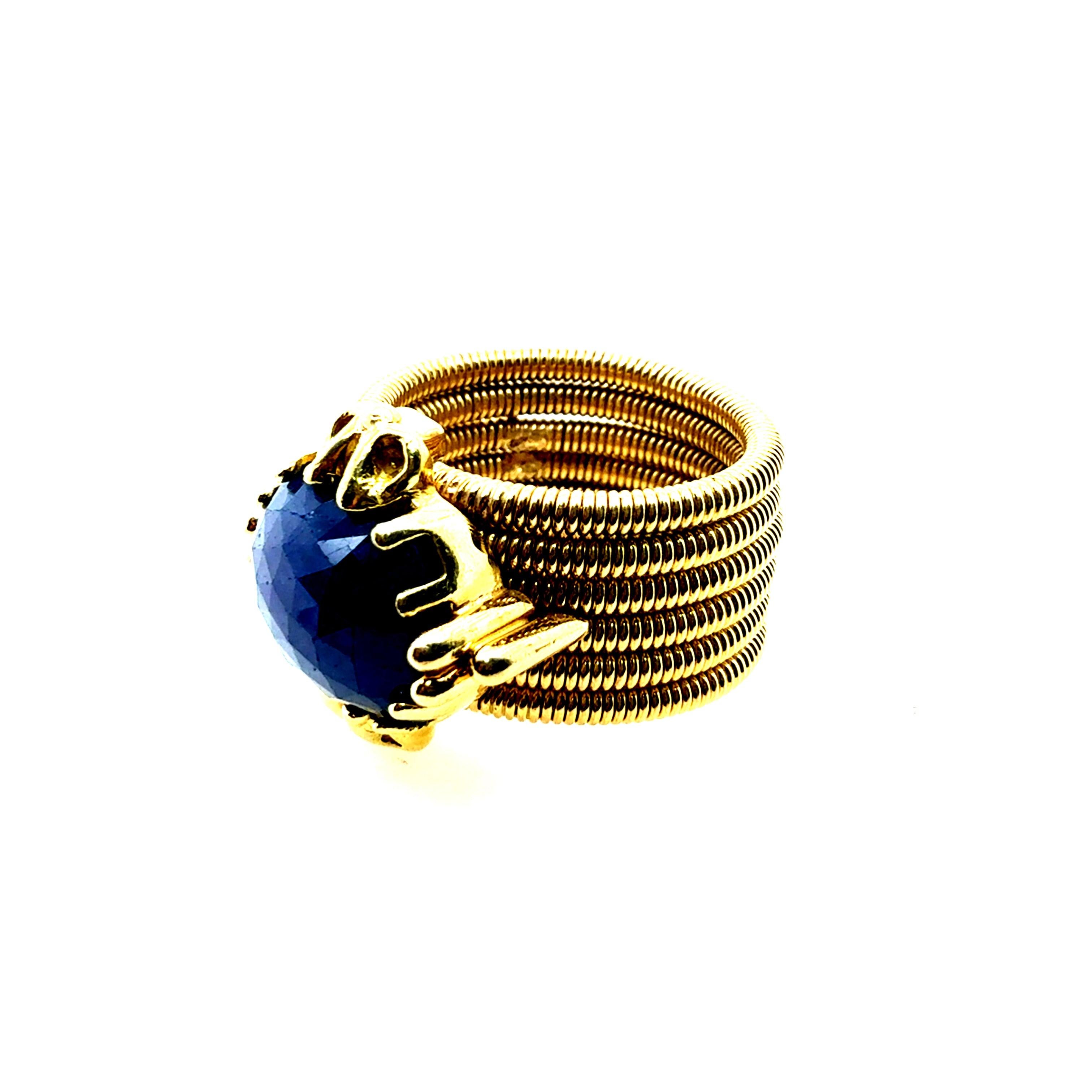 Retro yellow gold statement ring featuring a striking natural blue rose-cut sapphire weighing approximately 9 Carats, measuring approximately 11.5 x 10 mm. The band is about 12 mm wide, the ring weighs 21.2 grams, and it is a size 6.
Three