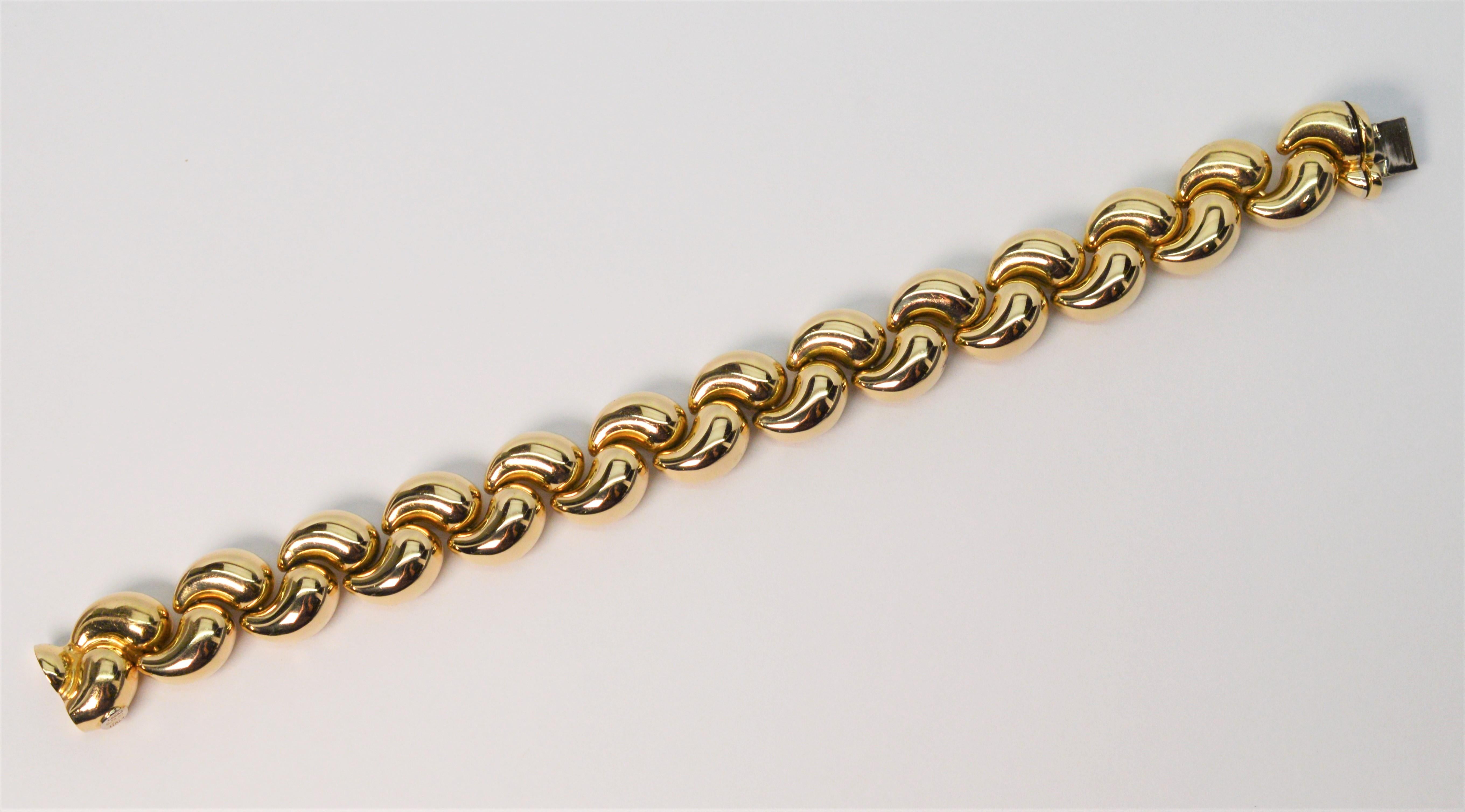 The many contours of this Italian made stylish bracelet evoke feminine elegance in fourteen karat 14K yellow gold. Interlocking hollow gold links give an infinite look to this elegant highly polished statement piece.  With a contemporary weave