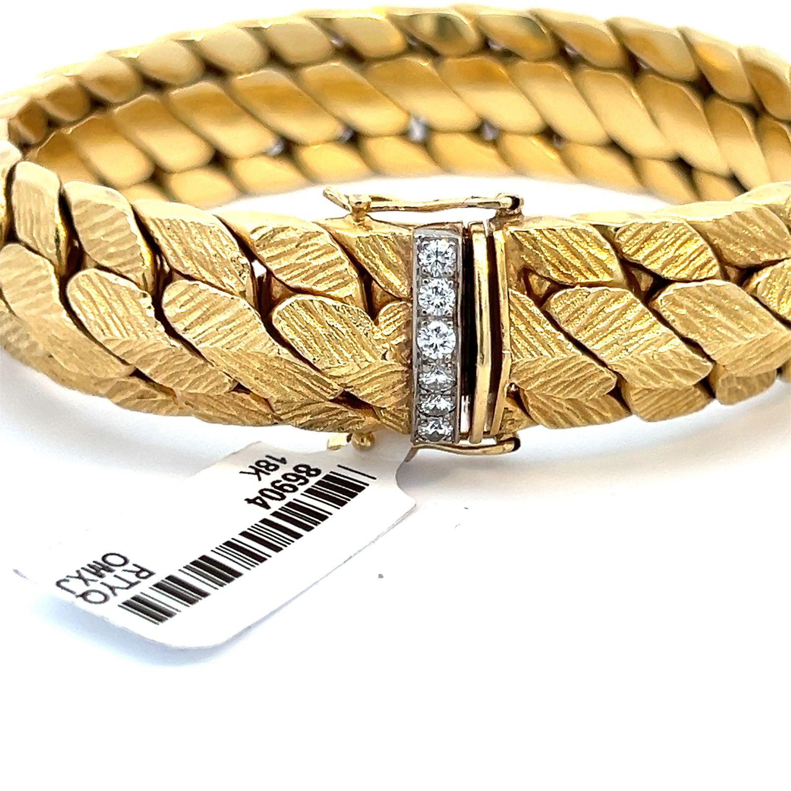 Retro 18 karat Yellow Gold Woven Florentine chain-link bracelet with diamond clasp. The bracelet is 18 karat solid yellow gold weighing 88.1 grams. The white gold clasp has six bezel set diamonds totaling 0.25 carats .The bracelet is 0.25 inches