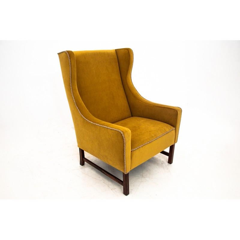 Vintage armchair comes from Poland from circa 1950s. 
This armchair has been renovated an upholstered with new yellow soft material. Solid oak construction.