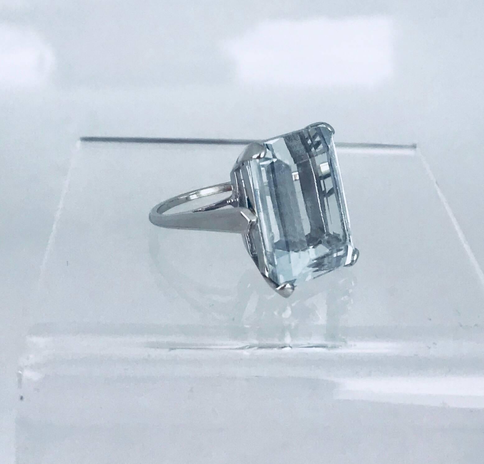 One 14 karat white gold emerald-cut, Aquamarine ring. a Retro style This ring is designed in a stunning simple setting to show off the beautiful blue hue of the gemstone.  The ring size is 4- 3/4. 
The measurements of the stone are 12.16 x 16.22 x
