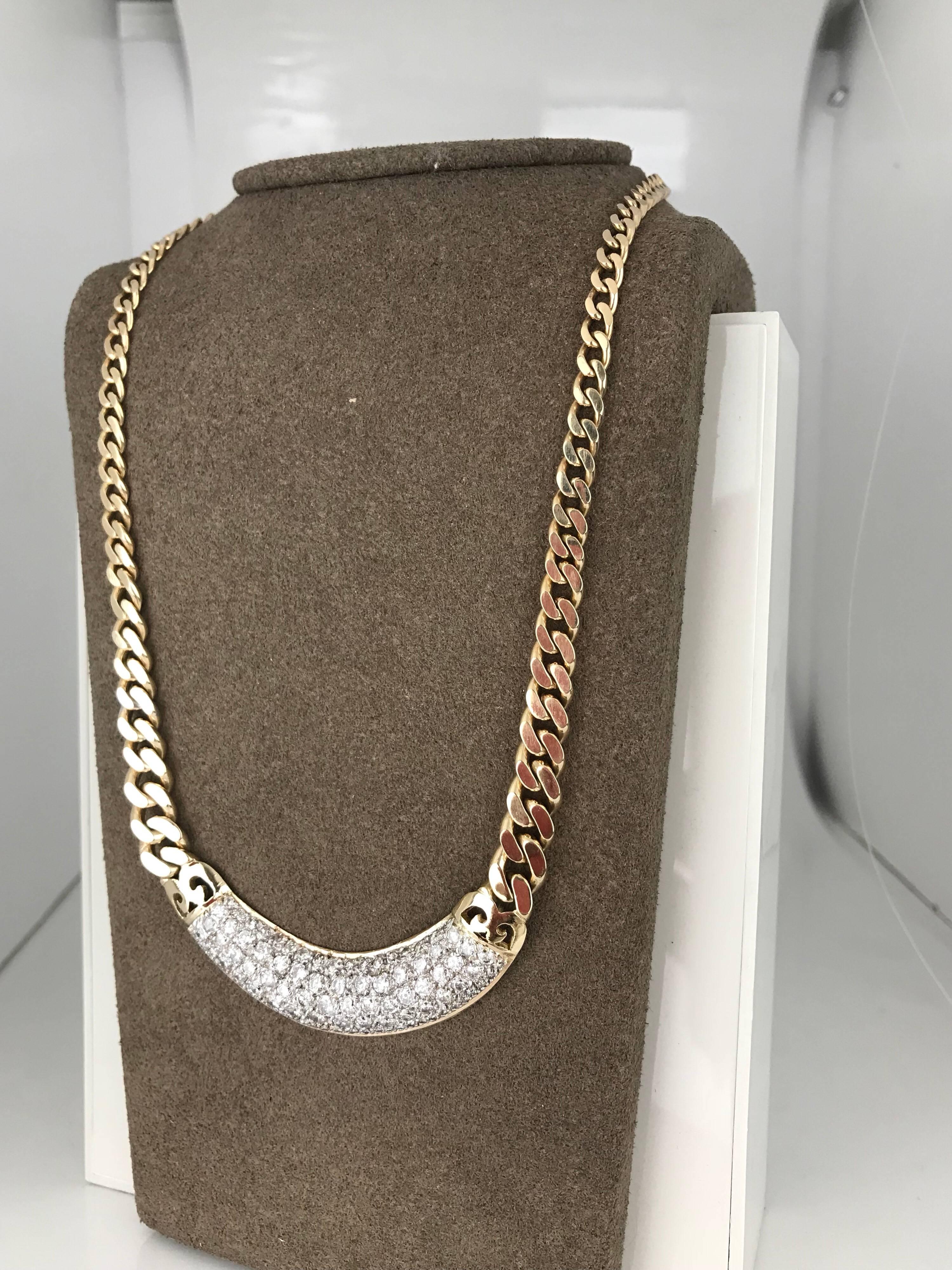 14 karat yellow gold open link necklace with a curved bar of 94 diamonds. The Necklace diamond bar measures 58 mm in length x 12.80 mm in width.


The chain is a curb link measuring 7.45 mm  in width and graduating to the clasp and links measuring