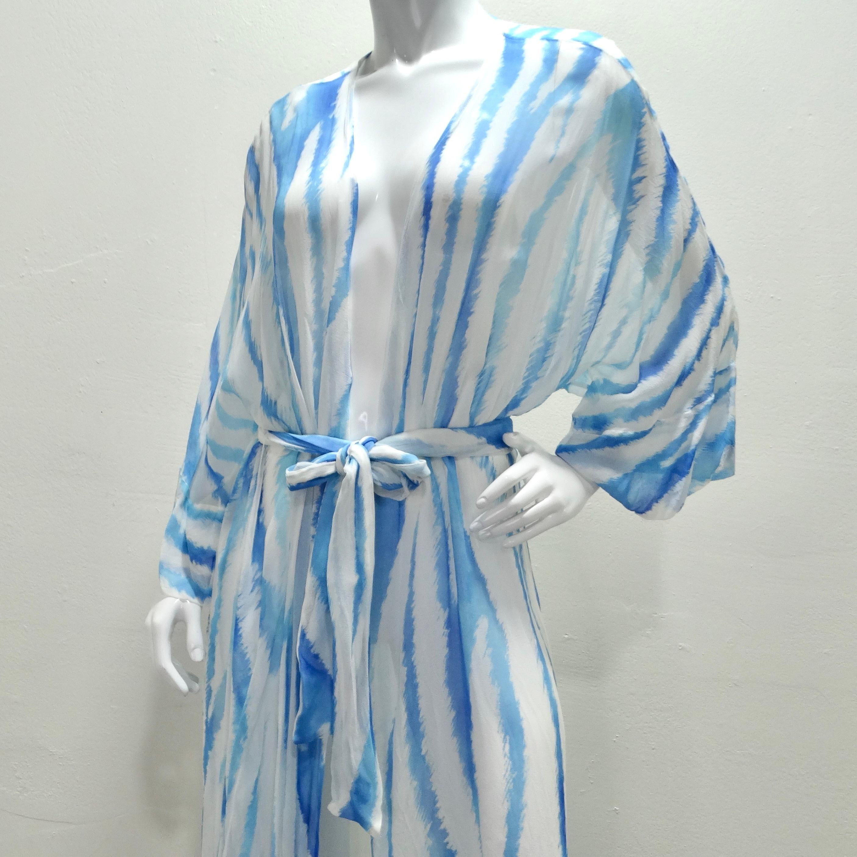 Introducing the stunning Retrofete Blue Zebra Silk Chiffon Robe, a versatile and luxurious piece that effortlessly transitions from beachside chic to evening glamour. Crafted from sheer silk chiffon, this airy maxi silhouette exudes elegance and