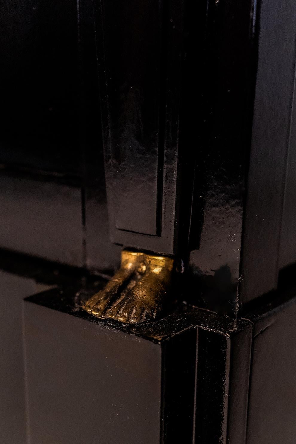 Black lacquered eturn from Egypt style chest of drawers in opening with three drawers decorated with caryatids, draw rings with lion's muzzles. France, 19th c. 