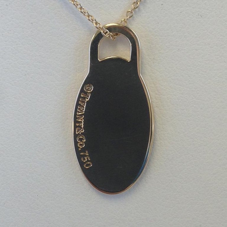 Return to Tiffany and Co. 18 Karat Yellow Gold Oval Dog Tag Necklace