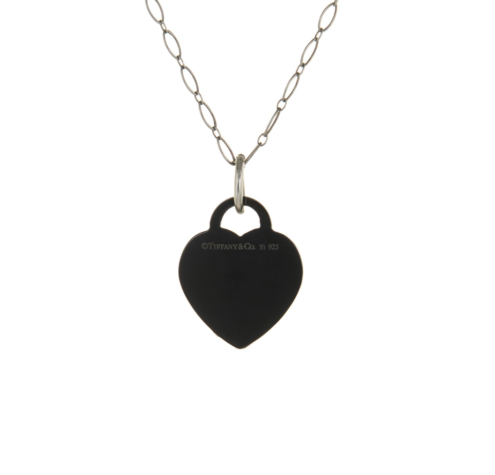 Pre-owned Return to Tiffany & Co heart necklace crafted in Titanium and Sterling Silver.  

The iconic Return to Tiffany & Co heart features a black titanium finish. The pendant comes with a 18 1/2 inch Tiffany & Co sterling silver chain.

The