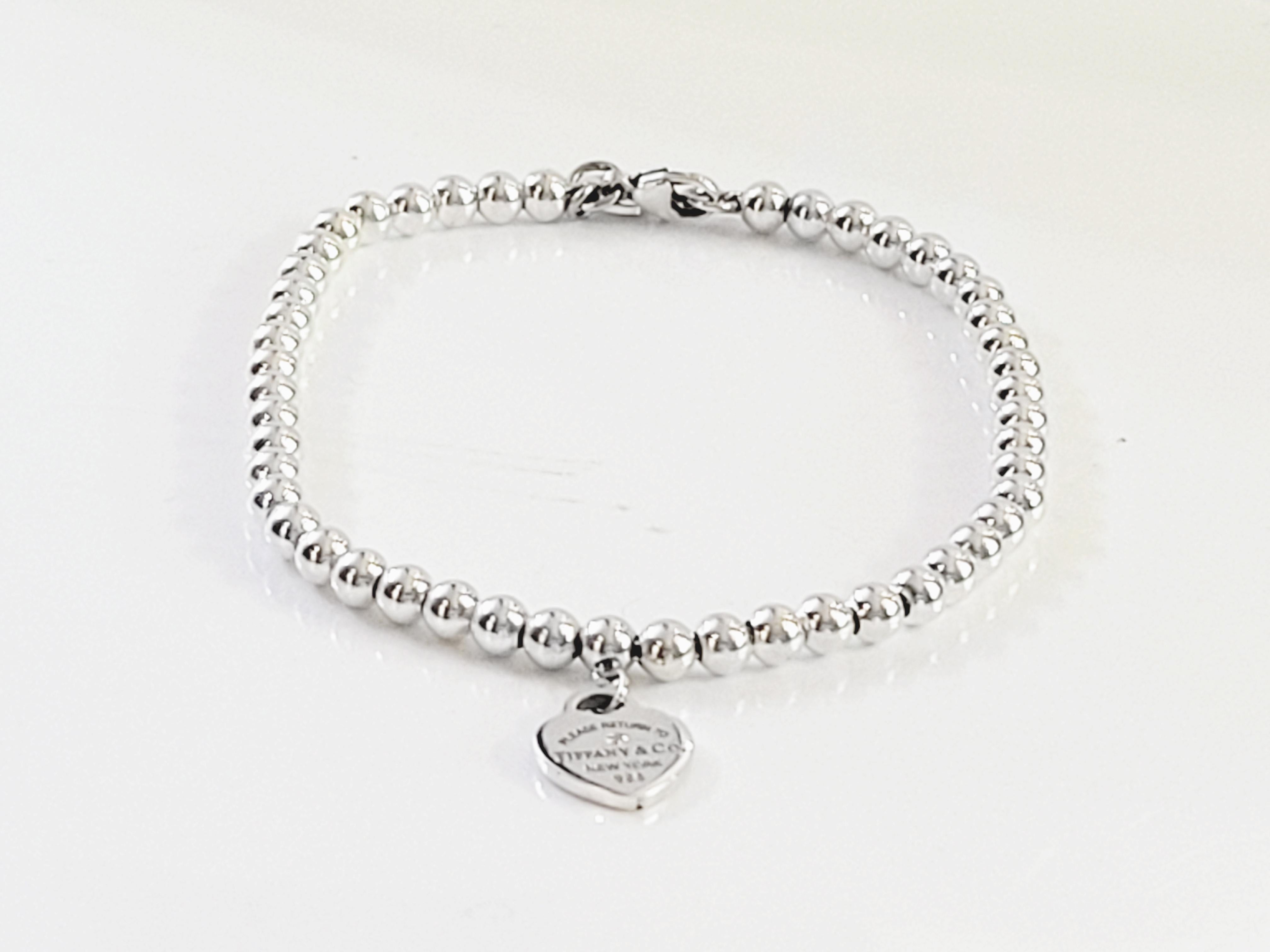 Brand Return to Tiffany & co 
Sterling silver with a round brilliant diamond
Mint Condition
Bracelet Length 7''
beads width 4mm
Weight 7.9gr
Heart tag width 10mm
carat total weight .005
Retail Price: $400