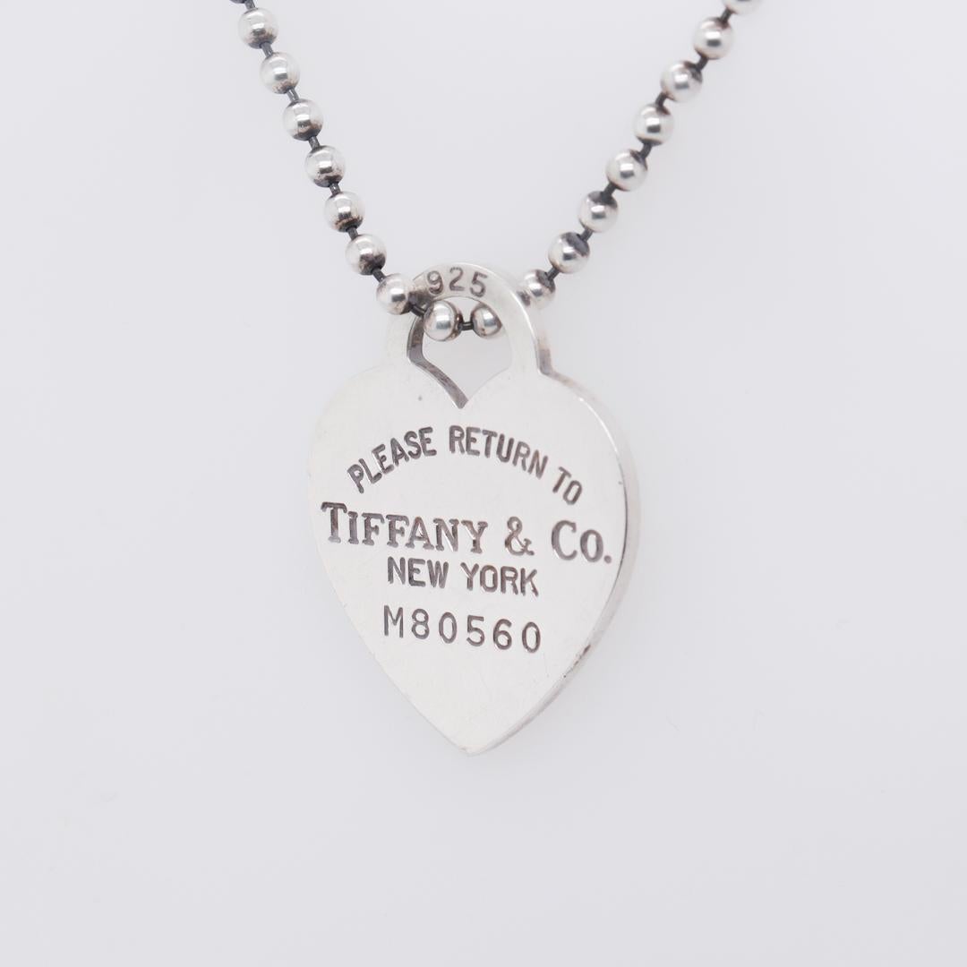 A fine silver heart tag necklace.

By Tiffany & Co.

In sterling silver.

With a heart shaped pendant reads 