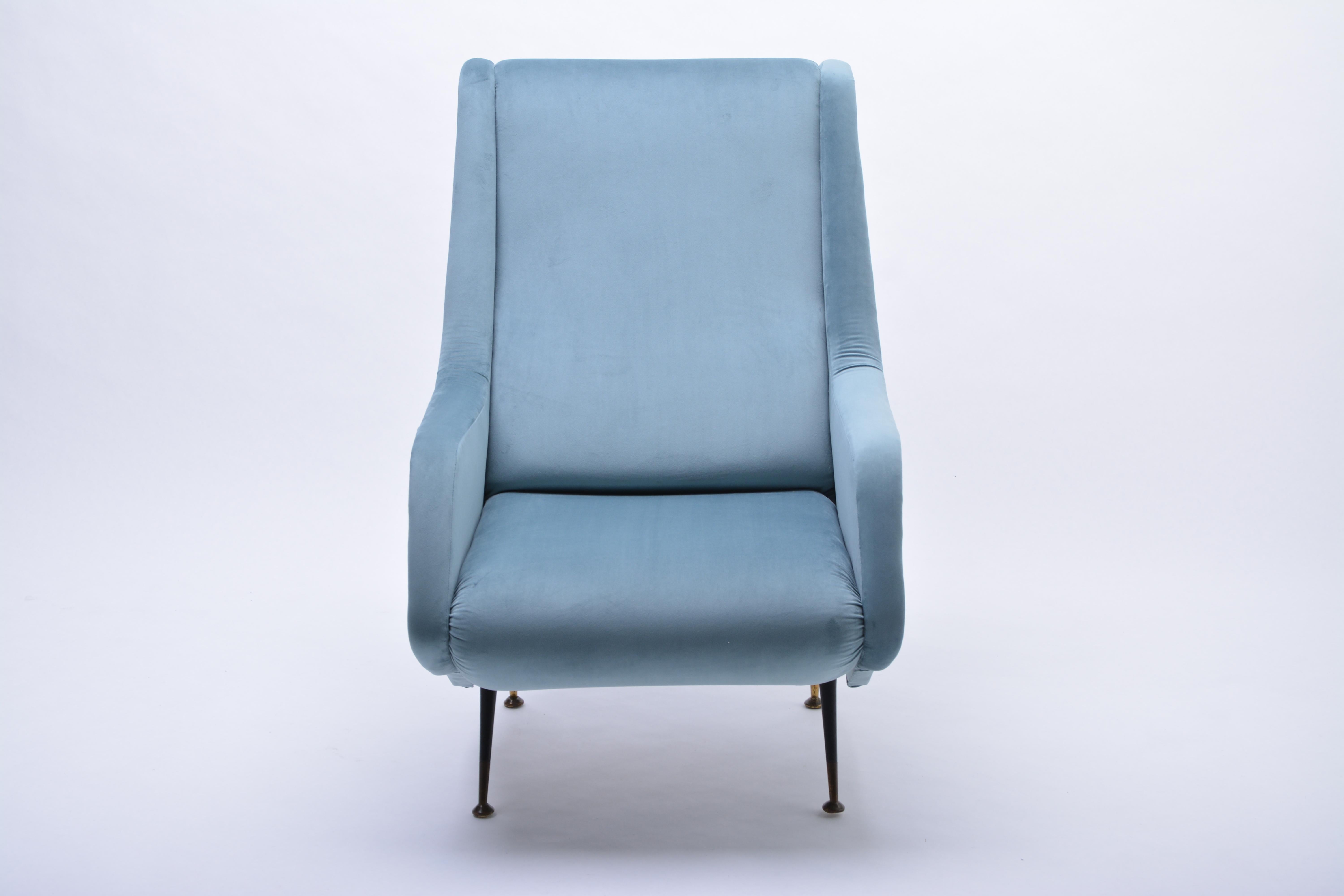Blue reupholstered Mid-Century Italian armchair in the style of Aldo Morbelli

This chair was produced in Italy in the 1950s. The chair has been restored and reupholstered with a velour fabric in powder blue. The legs are made of metal and brass.