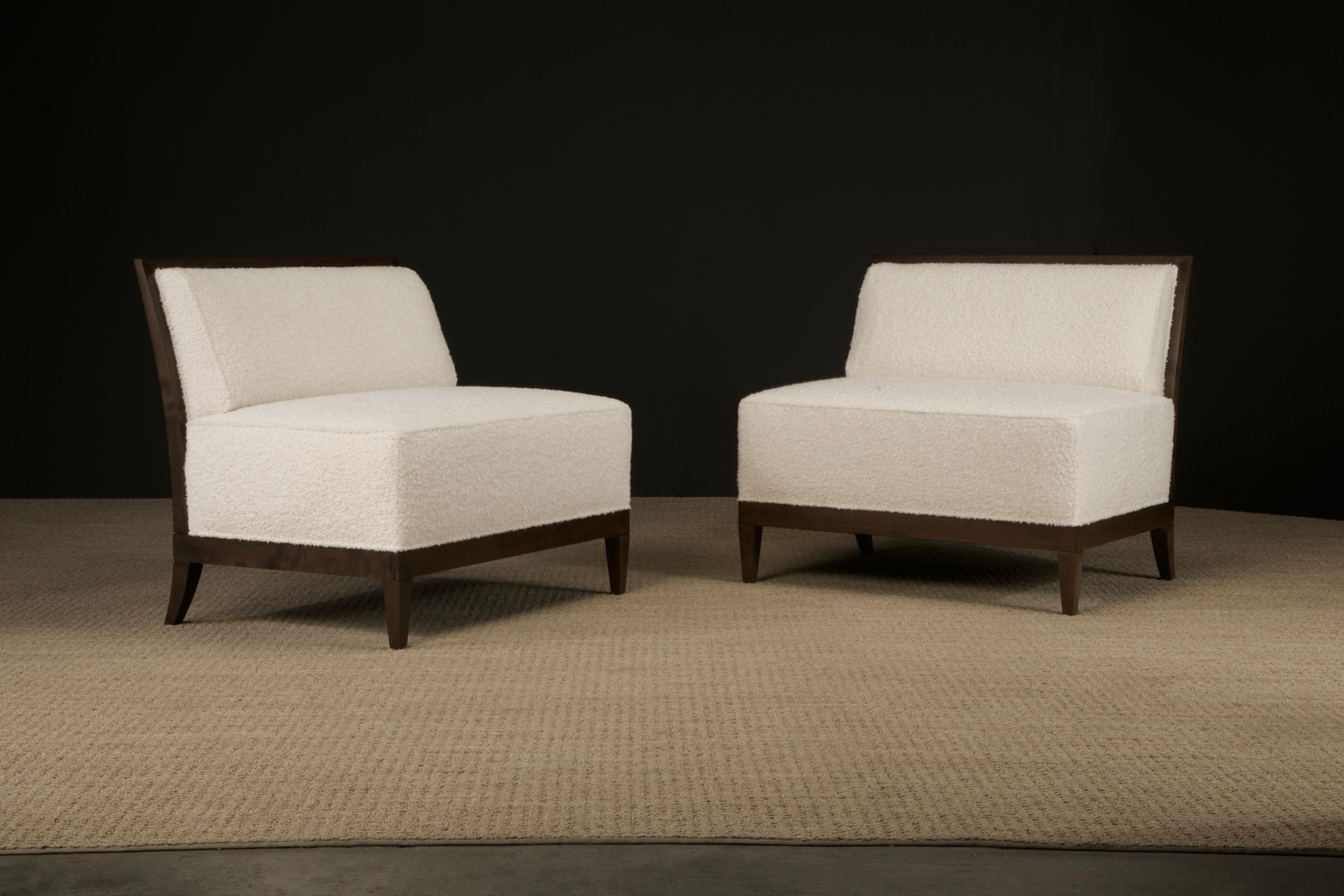 Beautiful pair of reupholstered and refinished circa 1980s Baker armless oversized lounge chairs, also works as petit settees, both signed with Baker medallions. Newly reupholstered in an off-white bouclé fabric. Wood frame features a geometric