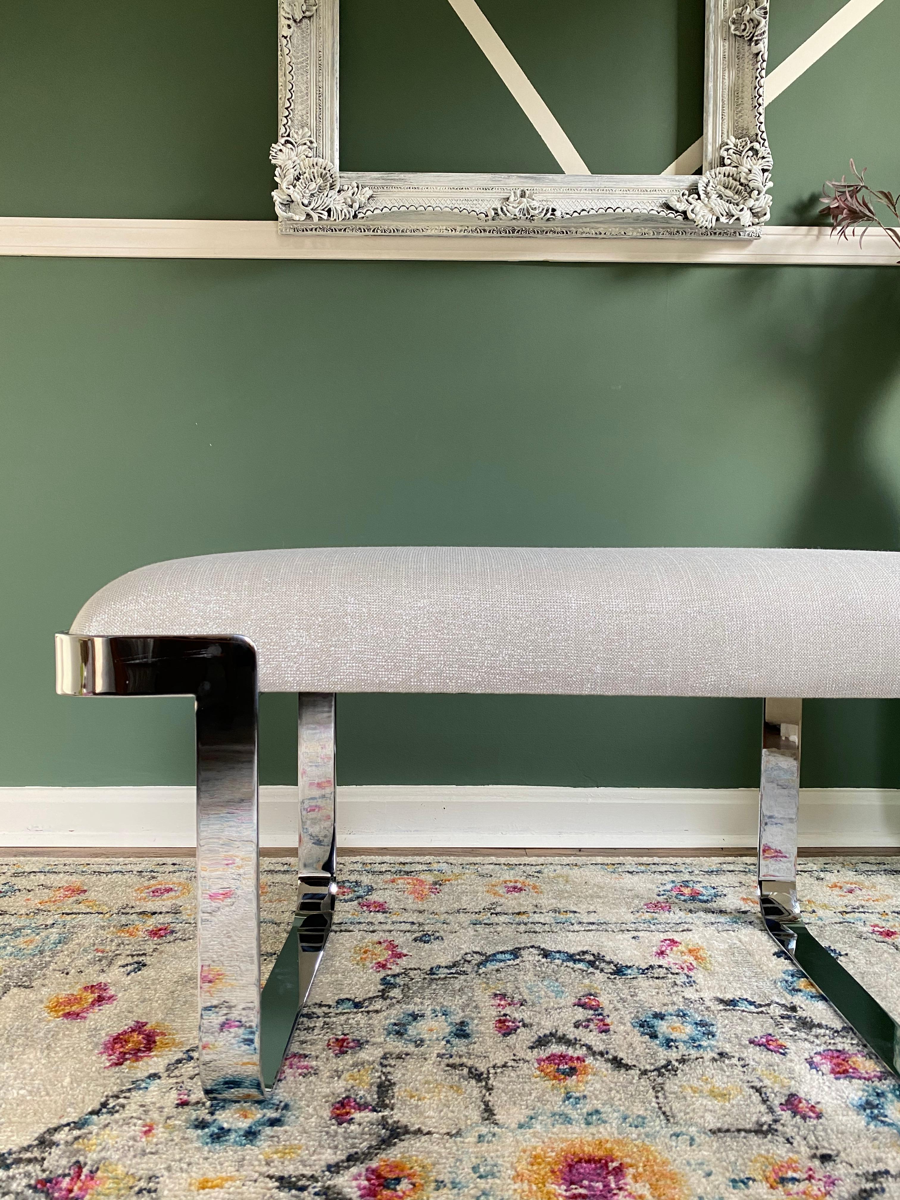 This chic Mid-Century Modern bench was realized in the United States, circa 1980. It features inverse L-form feet in lustrous chrome that create a cantilevered profile. The seat, offering elegantly considered proportions, has been newly