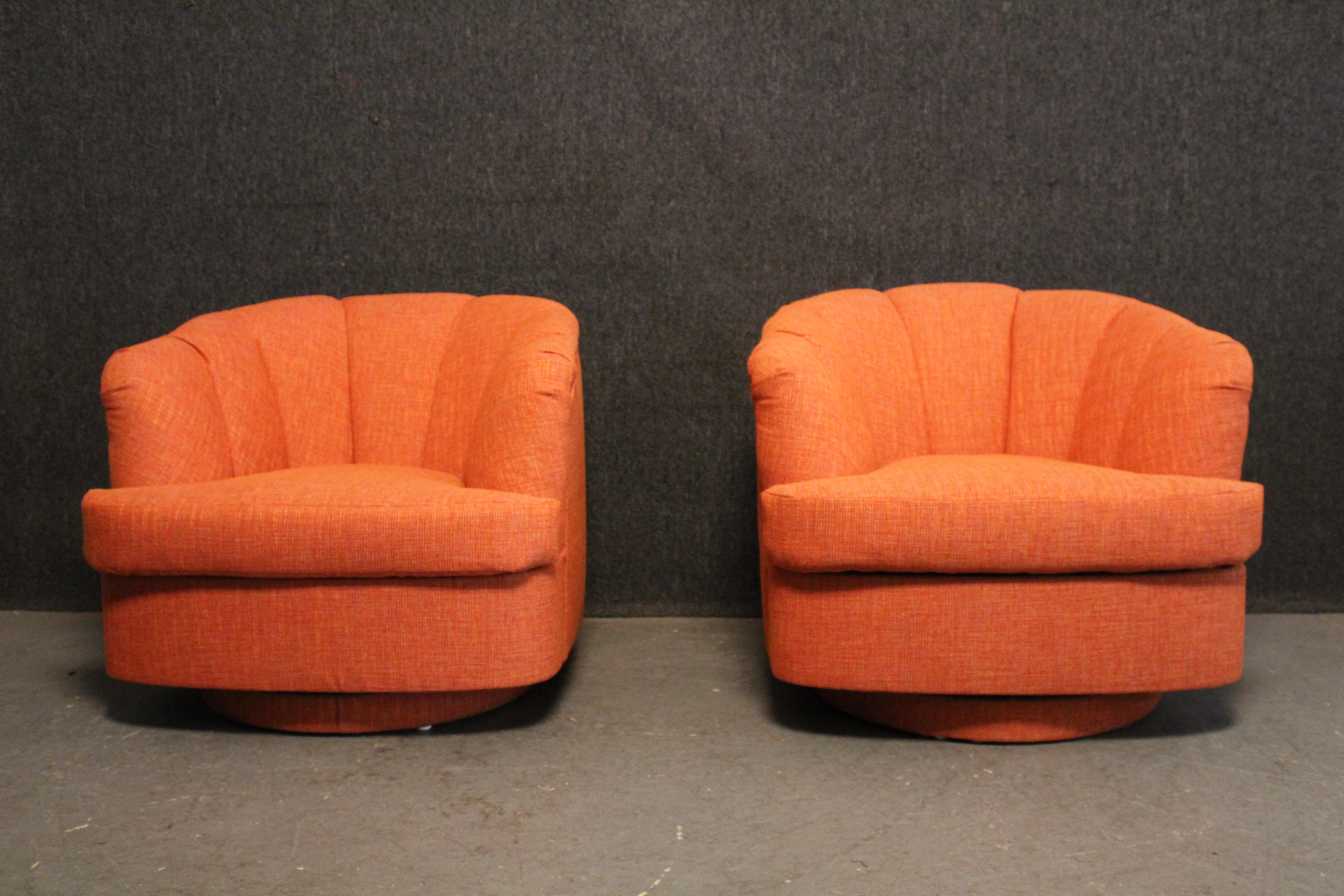 Blend a vintage look with a modern feel with this fantastic pair of newly reupholstered Mid-Century Modern lounge chairs made by Paul McCobb's Directional Furniture brand.  The overstuffed, swiveling chairs feature a deep, tub-like seat fully