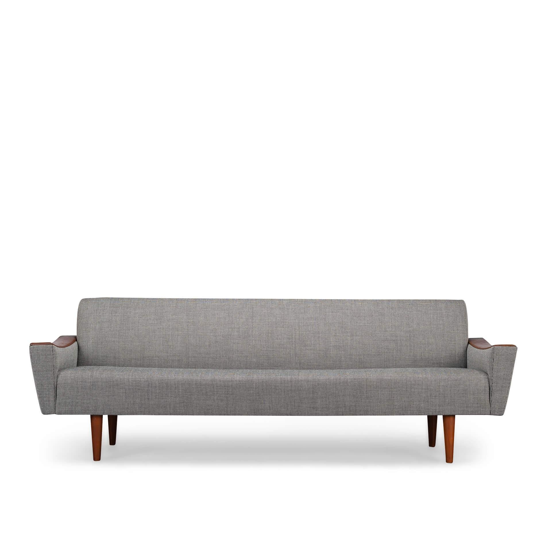 Stylish big sofa by CFC Silkeborg in stunning new upholstery in full accordance with the original upholstery. This sofa has a spacious yet straight seat. Ergonomic very wel suited to accommodate conversation and activity such as reading and work.