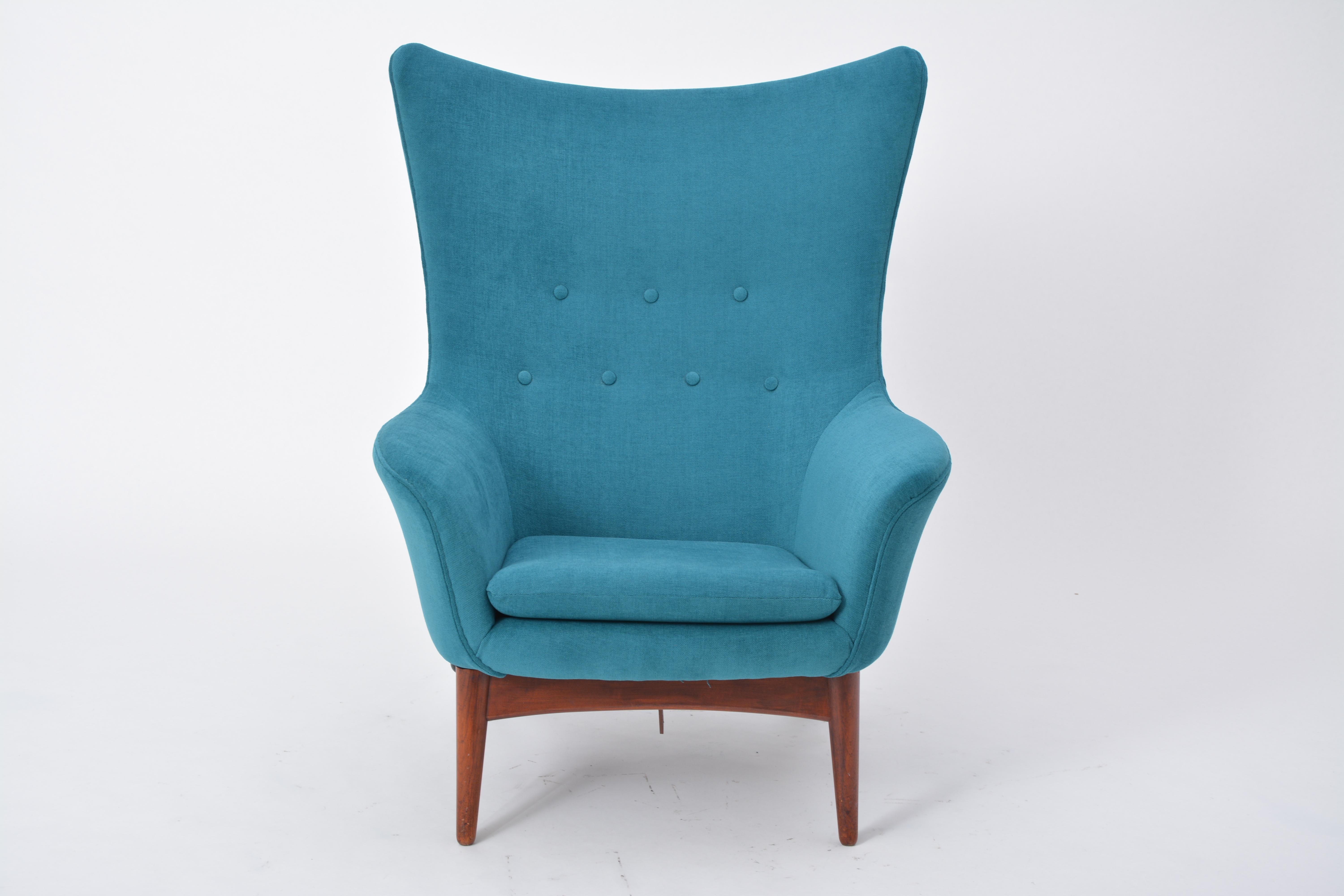Reupholstered Danish Mid-Century Modern reclining chair designed by Henry W. Klein

The chair has a rounded design with a subtle wing back and has a reclining mechanism adjusted with a knob on the right-hand side of the base. The base is made of