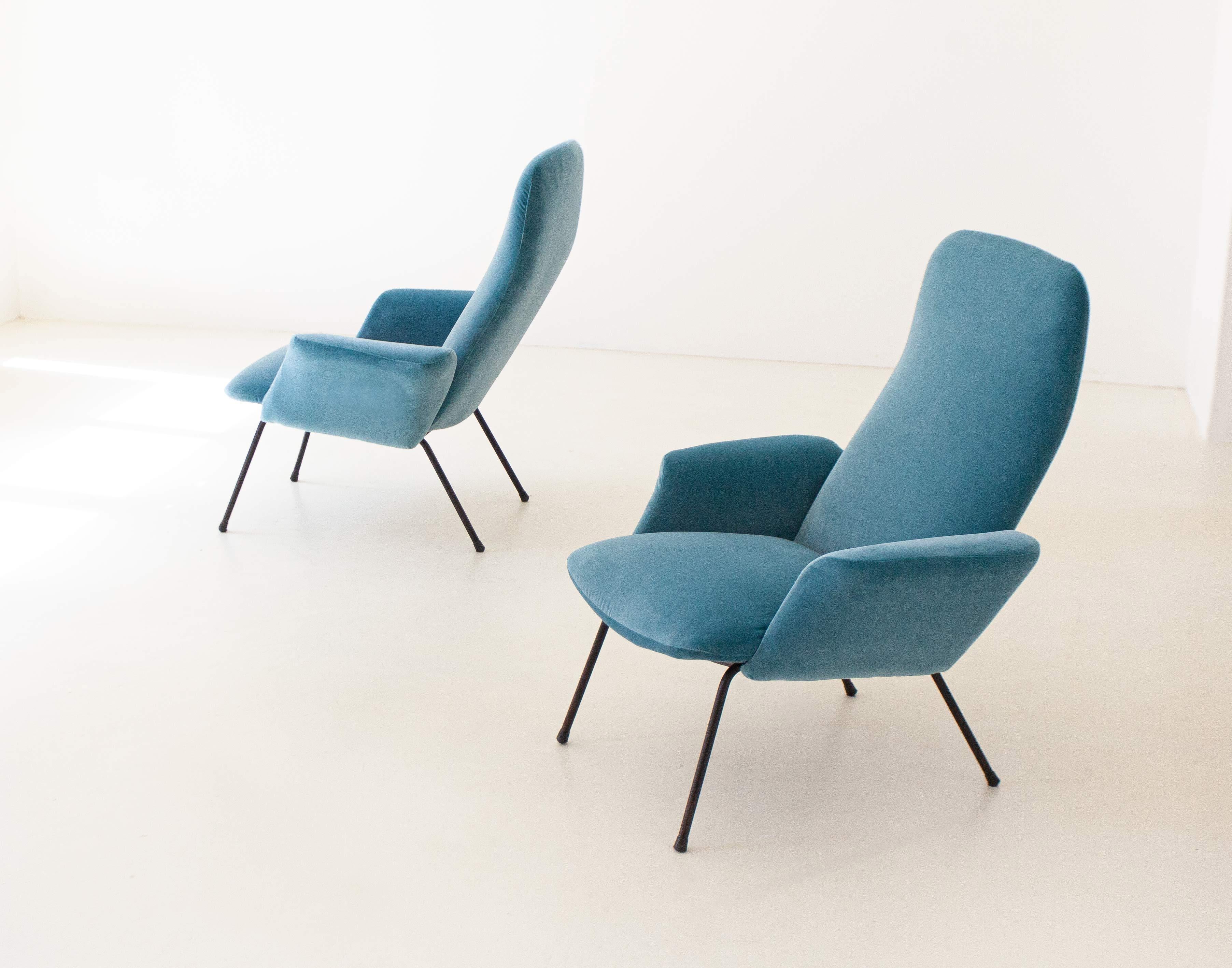 Set of two rare armchairs designed and produced in Italy during the 1950s.

These original retro' armchairs has been reupholstered with new light blue cotton velvet, also the padding is new. 
We have also worked on the legs with new black enamel