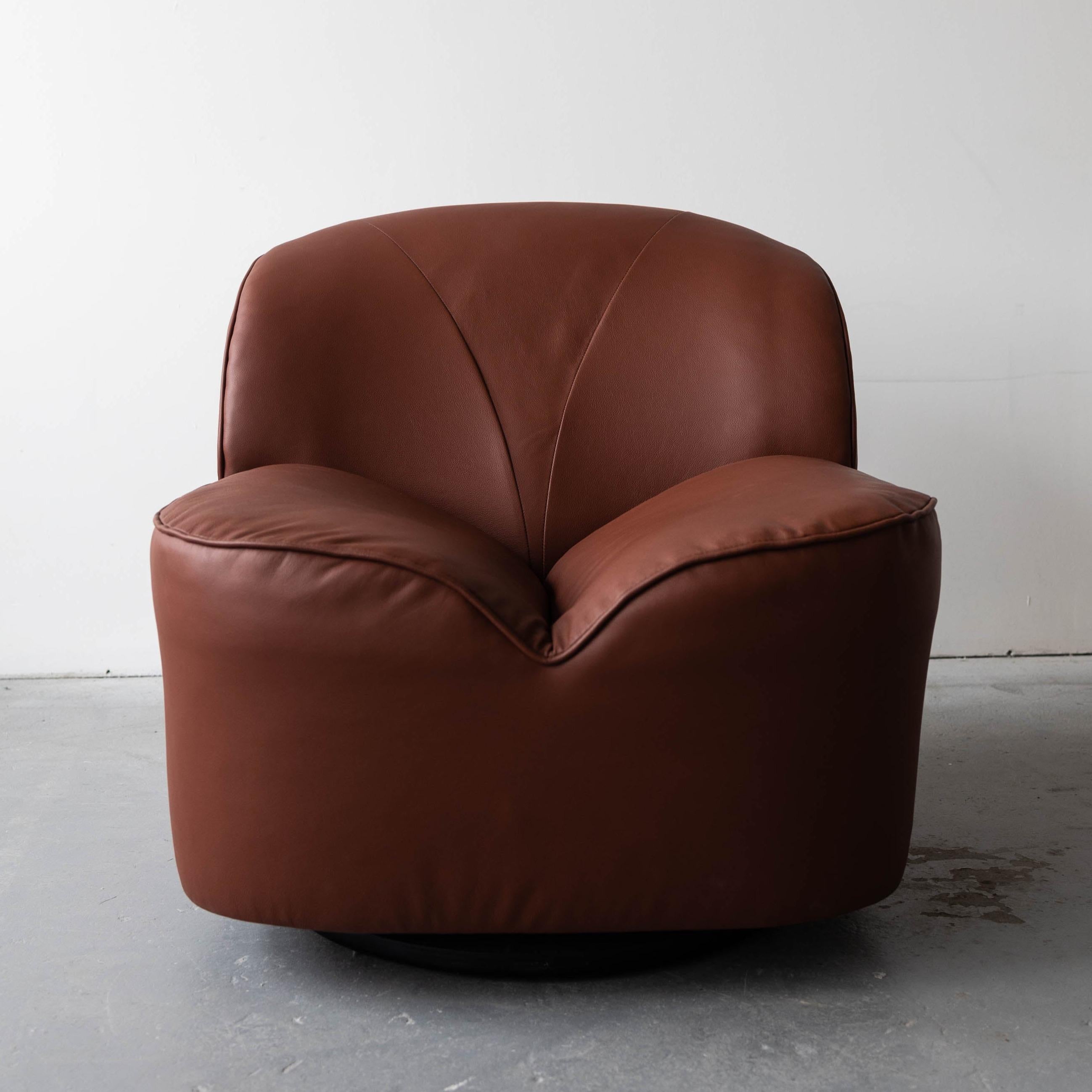 We used the highest quality, Italian full-grain leather by Spinneybeck when we redesigned and reupholstered this vintage swivel / tilt chair by Directional. It is incredibly plush and comfortable and is a great statement piece for any room.