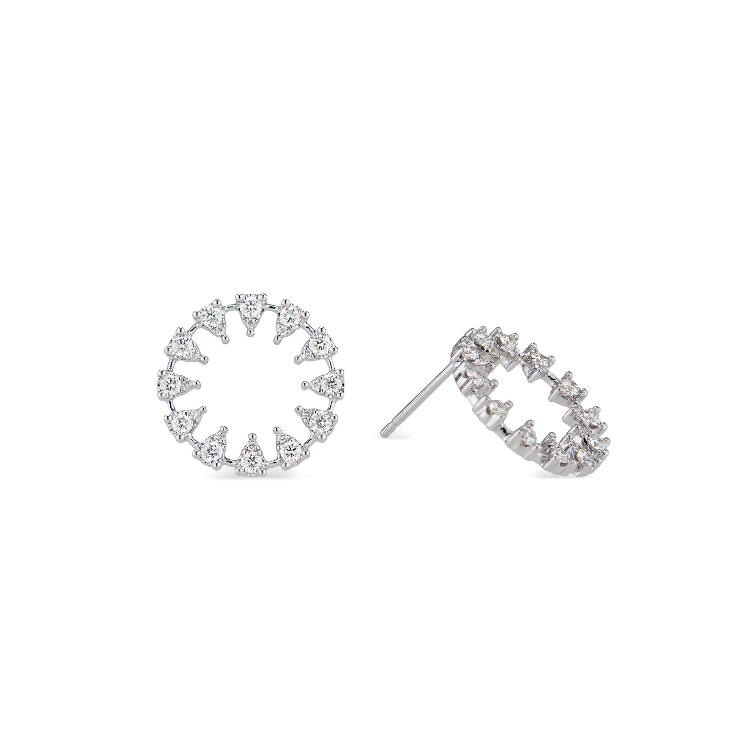 An circular hoop of triangles make a bold statement in Ri Noor’s Reve Round Diamond Earrings. Each triangle features a cluster of brilliant white diamonds, creating a dazzling visage that sparkles as it's hit by light. The unique earrings add a