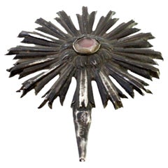 Revealed silver radiance with fake red stone in the center