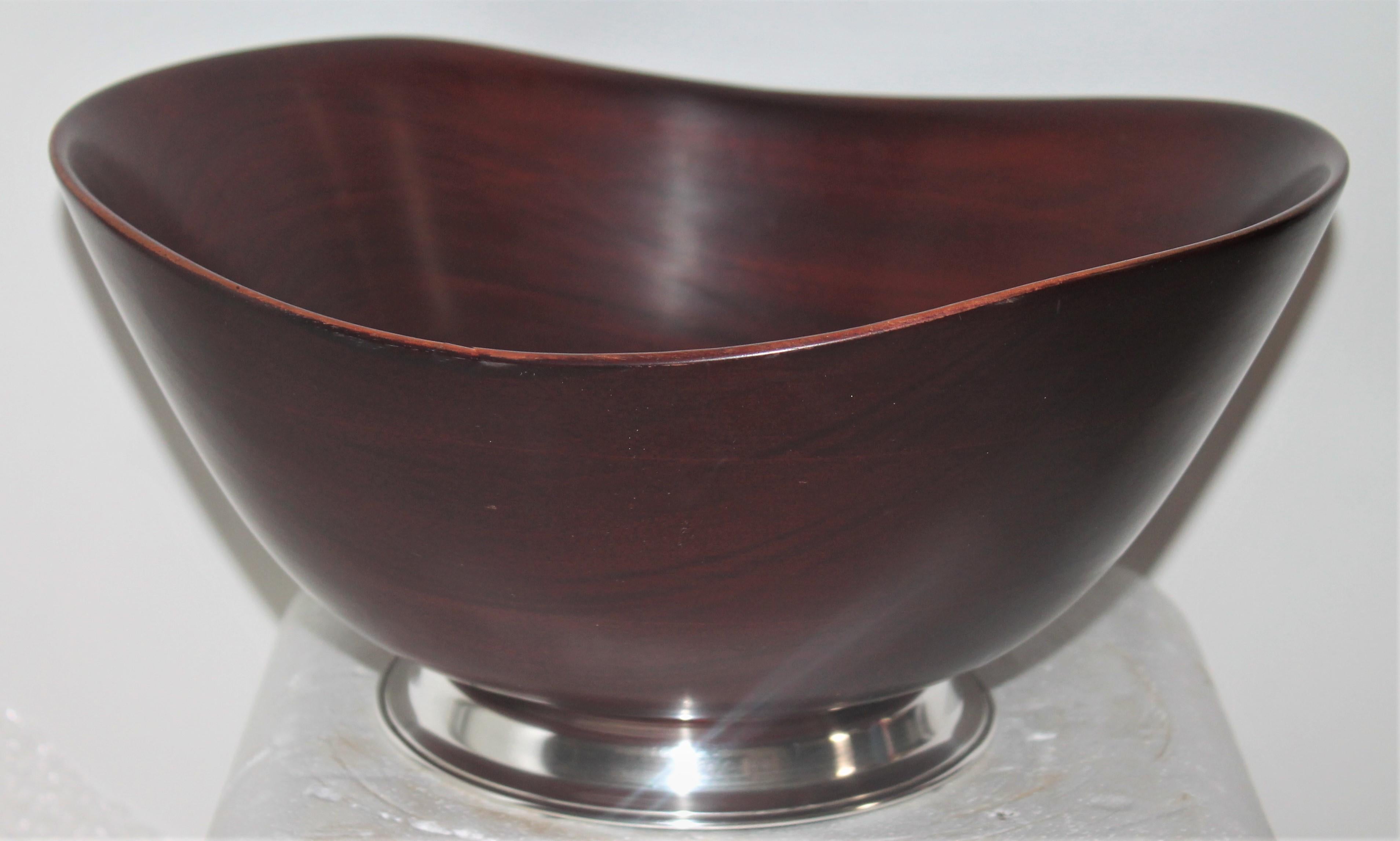 Large salad bowl with sterling silver base signed sterling. This midcentury mahogany salad bowl is in fine condition with a nice heavy sturdy base.