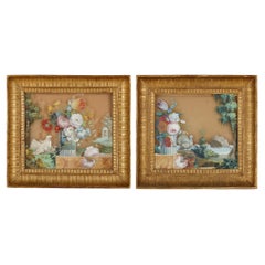 Reverse glass floral paintings in giltwood frames