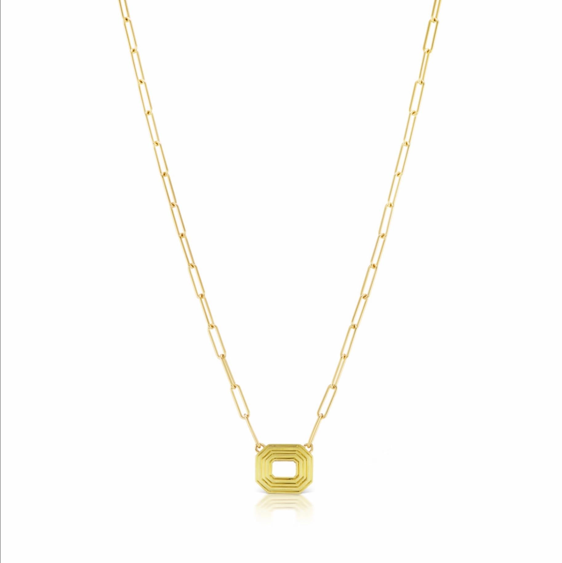 A very chic 18K necklace meant to be worn in two ways. One side has a double row of Black Enamel while the other has a double row of etched Gold. An open space in the middle of the pendant adds intrigue as a continuous space from one side to the