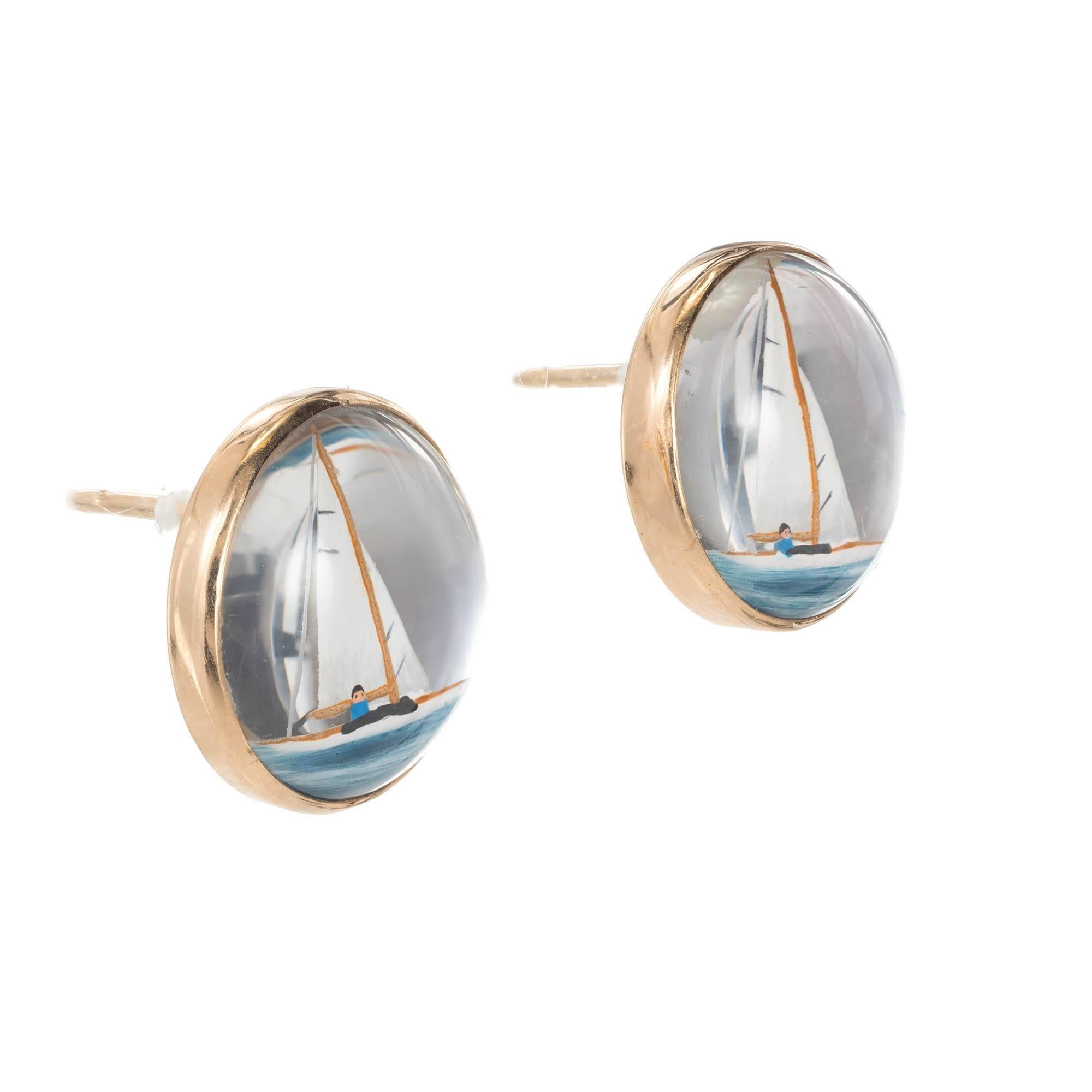 Reverse hand painted Quartz 14k yellow gold earrings. Carvings of a young boy on a sail boat. Pierced style

13mm top quality reverse carved Quartz crystal hand painted sail boats
Pierced posts
14k Yellow Gold
Stamped: 14k engraved MEM
5.6
