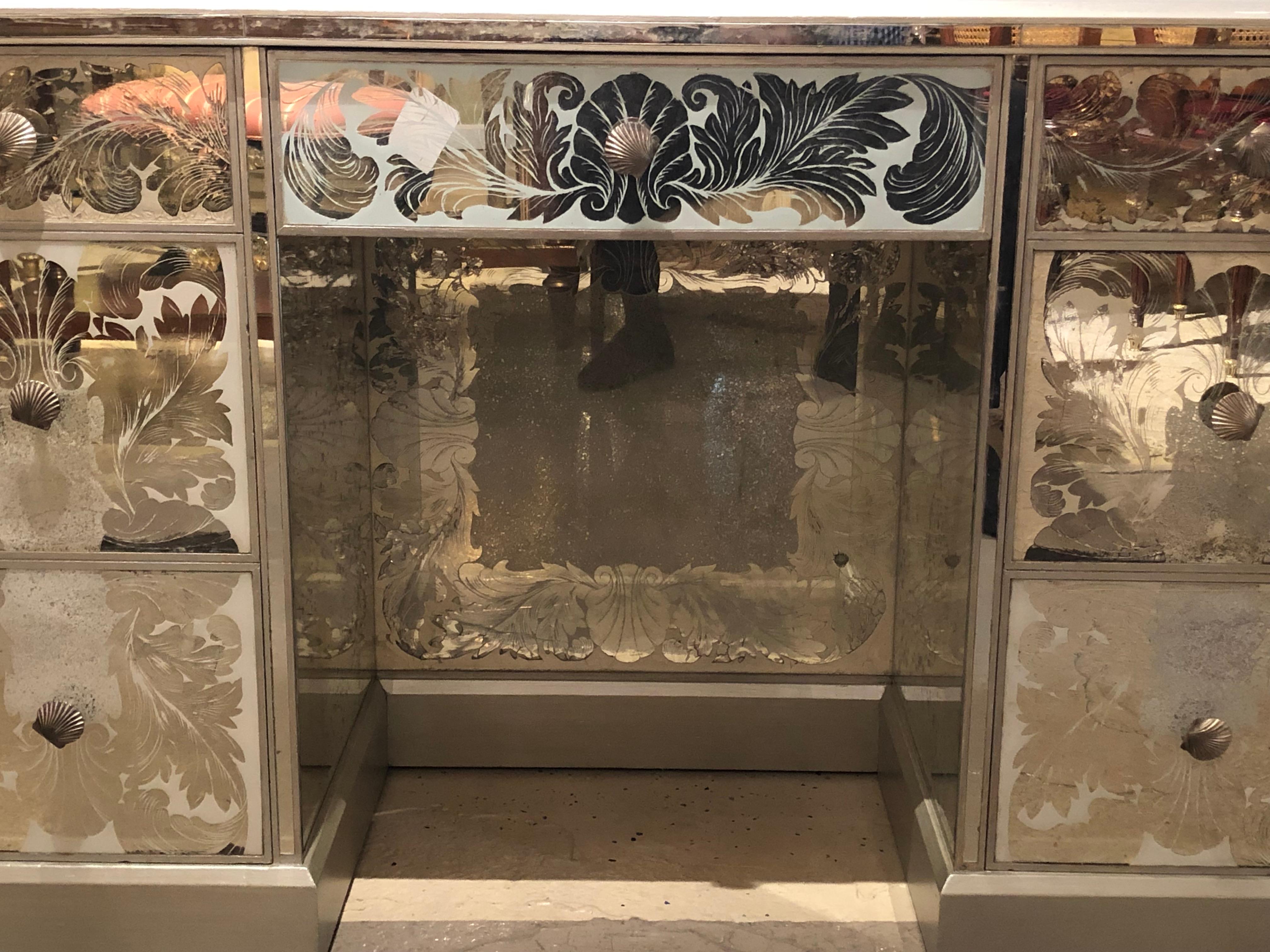 A reverse paint decorated Hollywood Regency desk or vanity from the vintage deco era. This stunning vintage desk comes from part of a vast collection of mirrored and glass merchandise fresh from a Greenwich CT mansion of a Gentleman. This foil