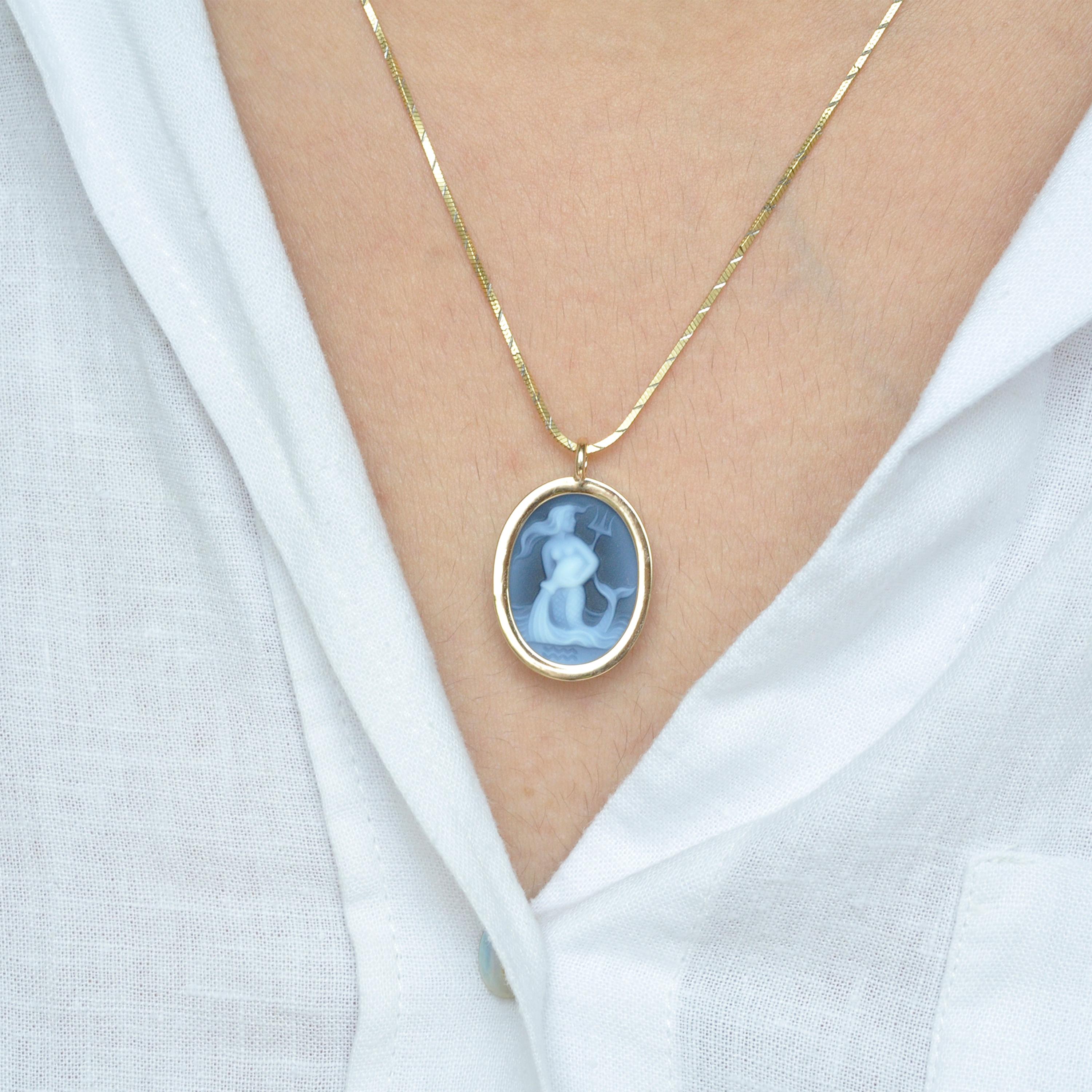 Reversible pendant necklace featuring aquarius sun sign carving cameo zodiac diamond in 14 karat gold.

Introducing our signature aquarius sun-sign zodiac carving cameo reversible pendant necklace from the zodiac collection. The pendant is set in 14