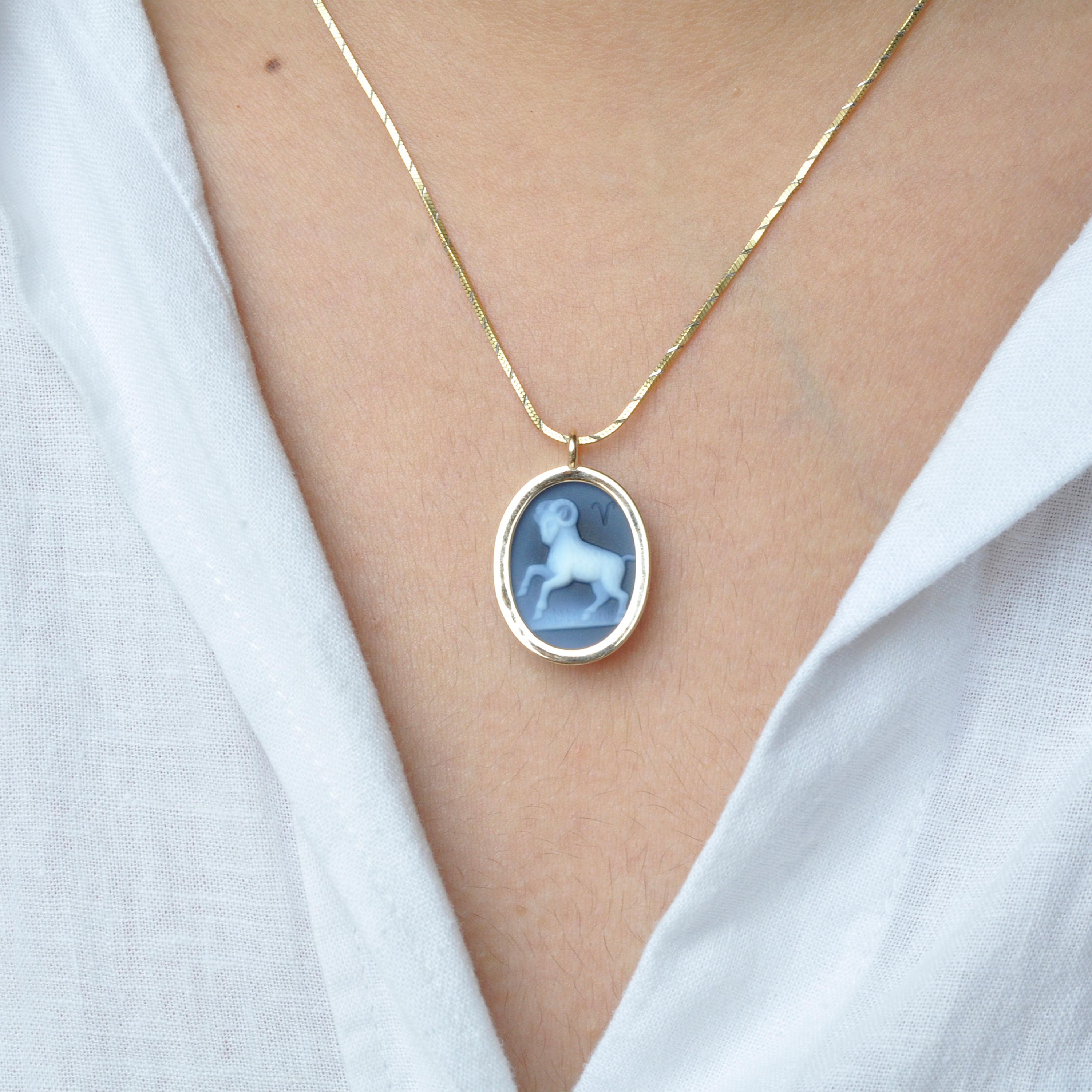 The reversible pendant necklace featuring an Aries sun sign carving cameo zodiac diamond in 14 karat gold is a stunning piece of jewelry that combines exquisite craftsmanship, elegance, and personalization. With its reversible design, it offers two