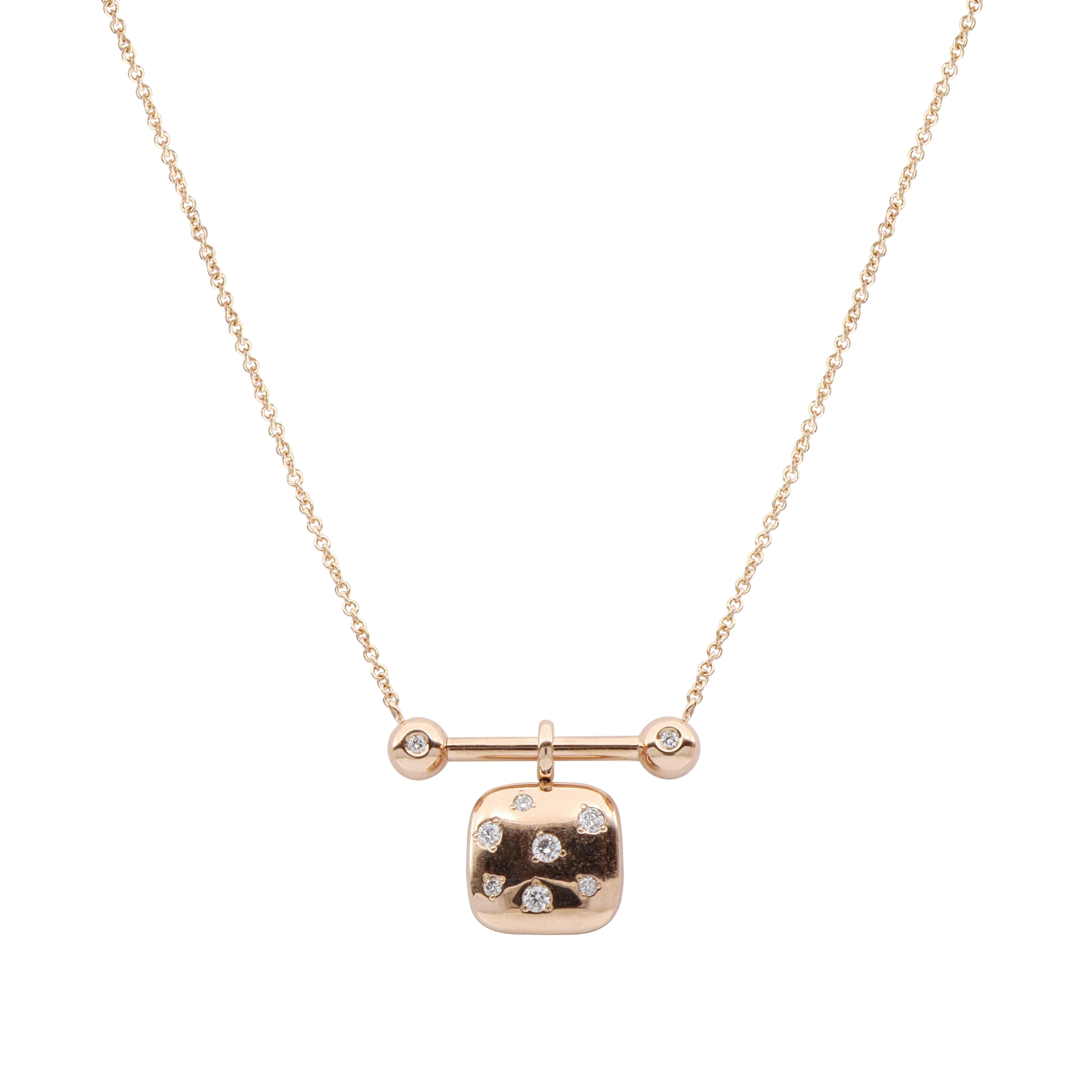 This unique, modern necklace is handcrafted in 18 Kt rose gold. The fine chain holds a polished gold bar design featuring two white brilliant-cut diamond accents. A reversible square pendant dangles from the center showcasing a black and white
