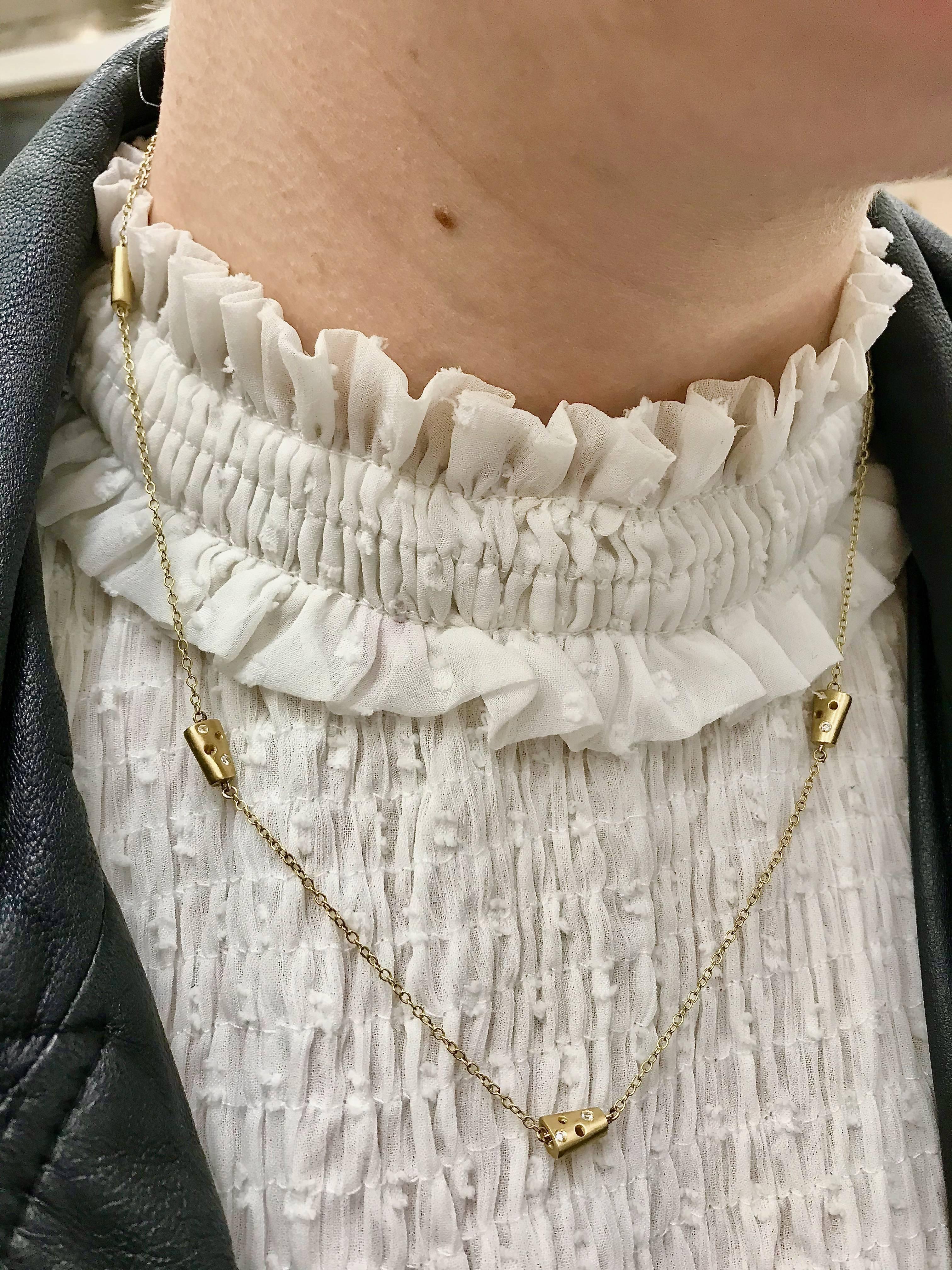 Tiny tapered and reversible 'helena' charms encrusted with white diamonds adorn an 18 karat yellow gold chain. This quietly bold chain is ideal for laying or wrapping around the neck to create a two layer necklace, or the wrist to wear as a