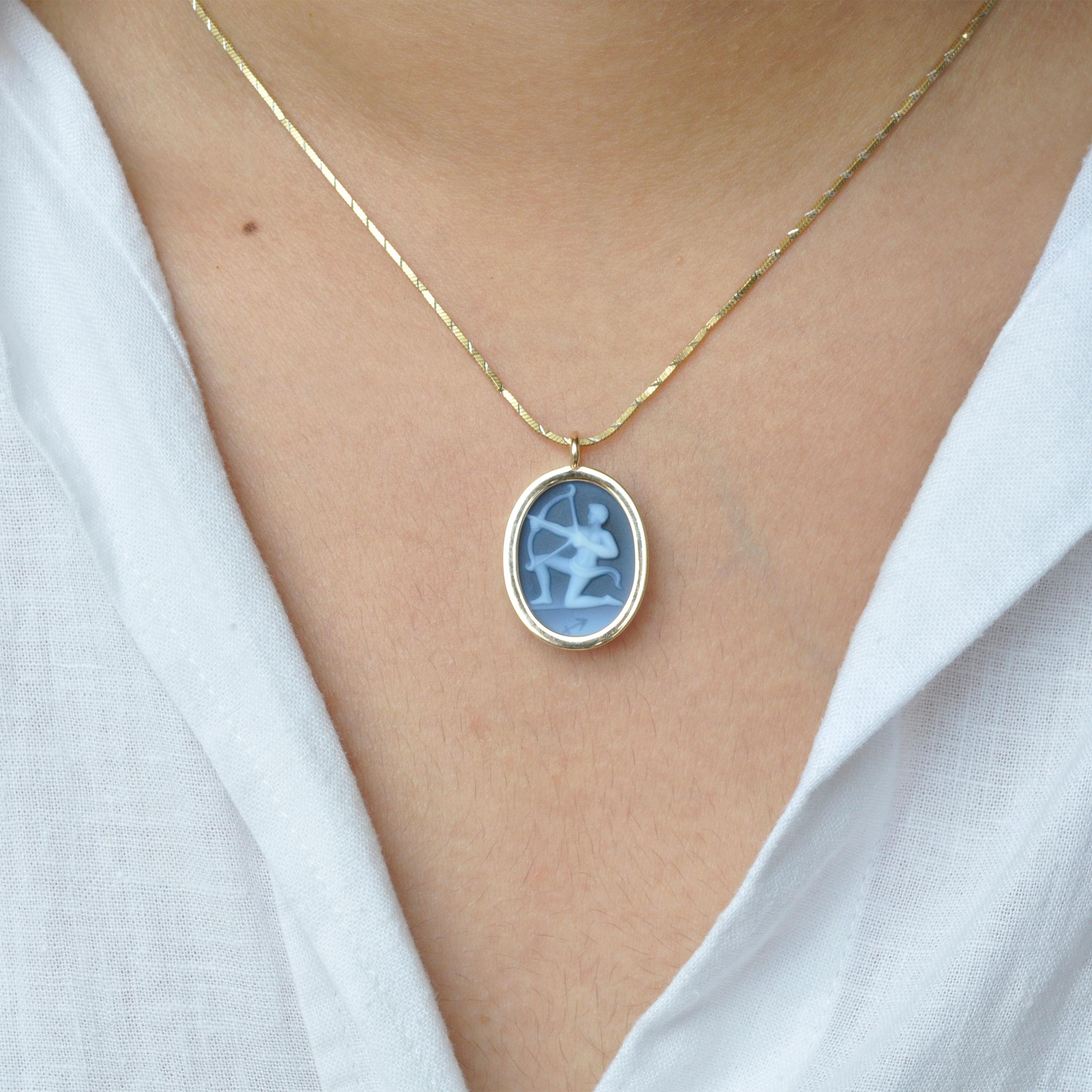 The reversible pendant necklace featuring a Sagittarius sun sign carving cameo zodiac diamond in 14 karat gold is a magnificent piece of jewelry that embodies exceptional craftsmanship, elegance, and personalization. With its reversible design, it
