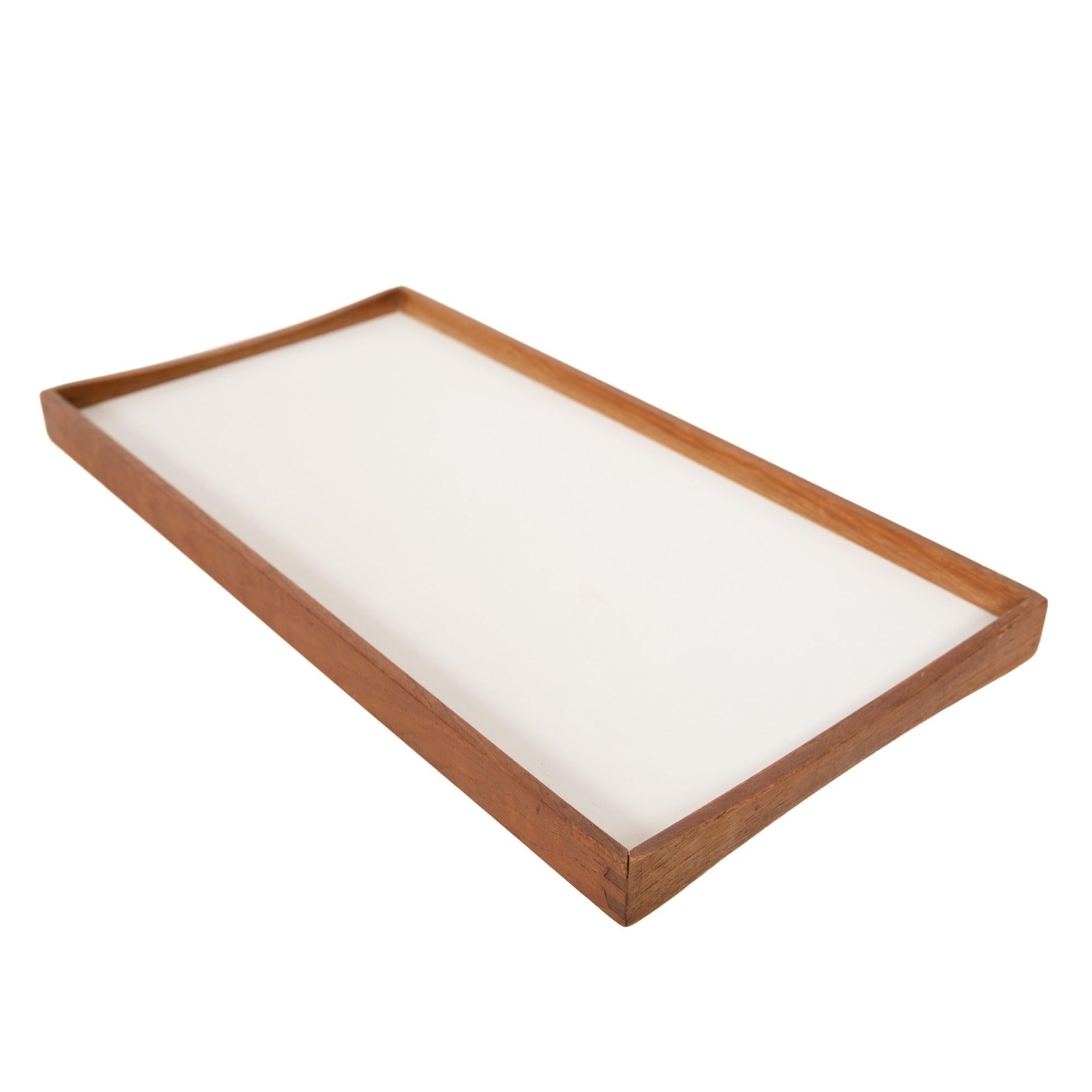 A beautifully crafted finger jointed teak frame serving tray, with white and black laminate surfaces