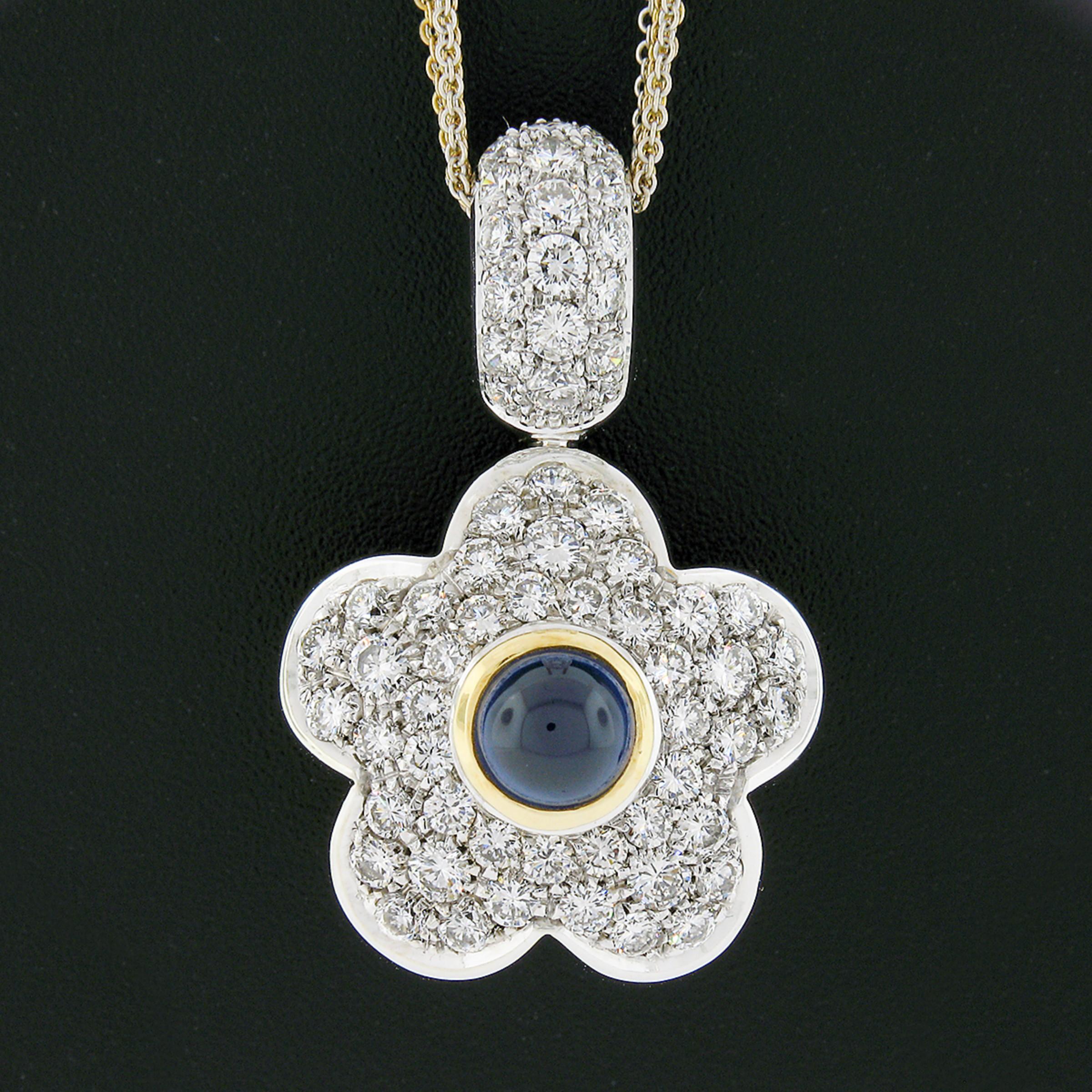 This incredible large puffed flower pendant features an ingenious reversible design that was crafted from solid 18k yellow and white gold. The front of the flower is drenched with round brilliant cut diamonds that are neatly pave set in white gold,