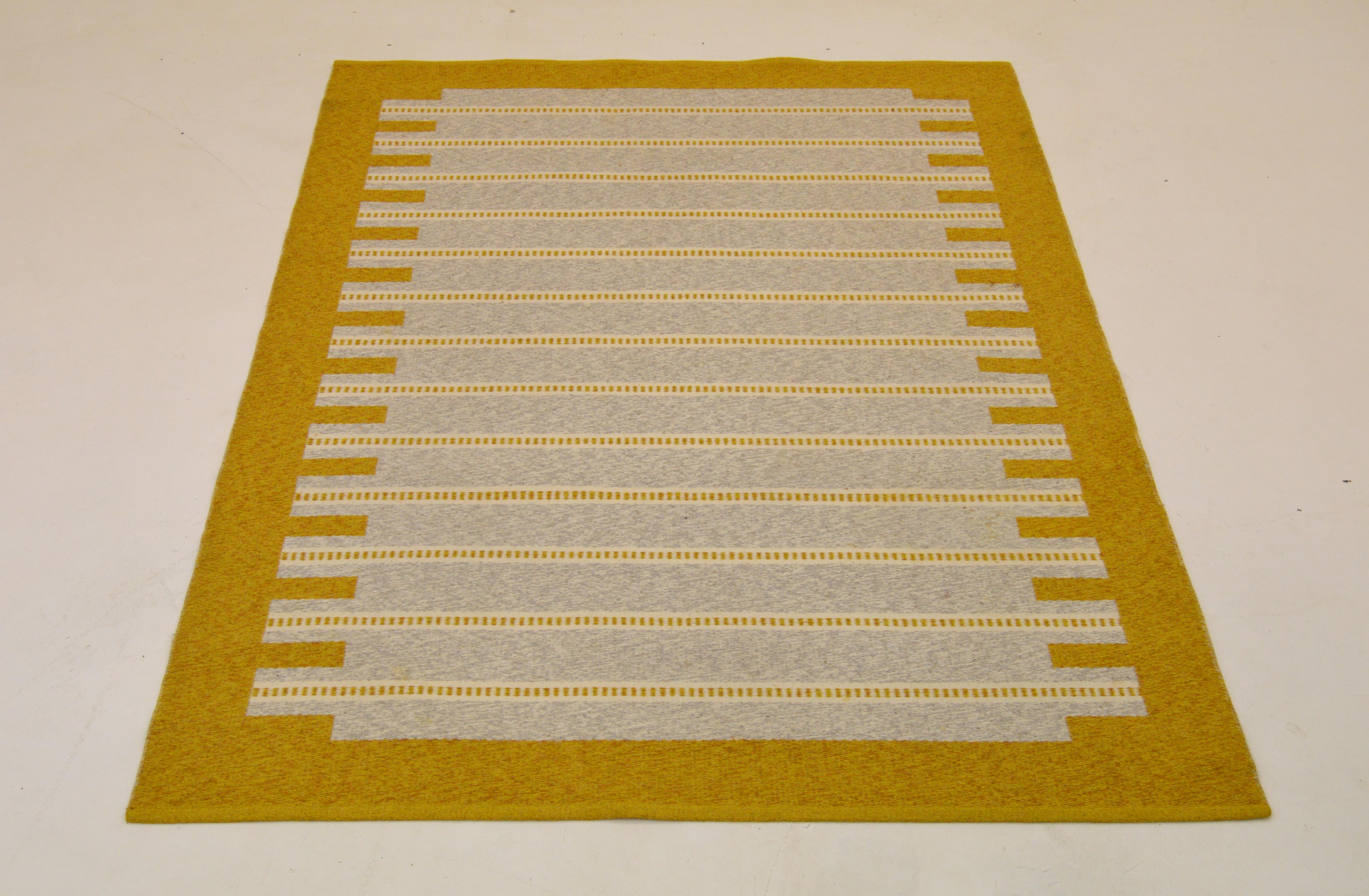 A Scandinavian Modern Rollakan carpet.
Made in Sweden during the 1950s-1960s, midcentury period. 

Handwoven wool. Yellow and grey are the dominant colors.
Good vintage condition with small signs of usage and minor stains.

Some missing