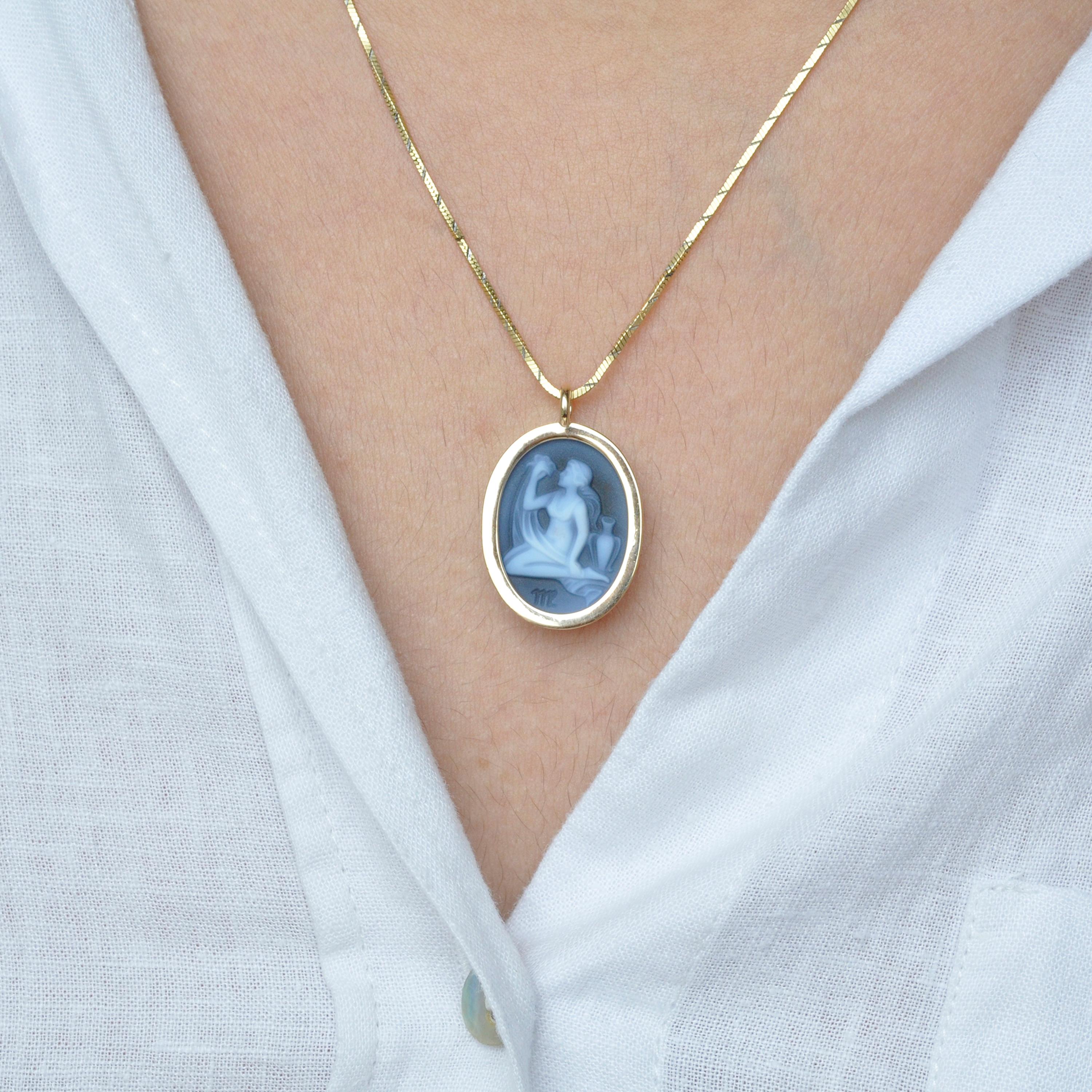 The reversible pendant necklace featuring a Virgo sun sign carving cameo zodiac diamond in 14 karat gold is a stunning piece of jewelry that embodies exquisite craftsmanship, elegance, and personalization. With its reversible design, it offers two