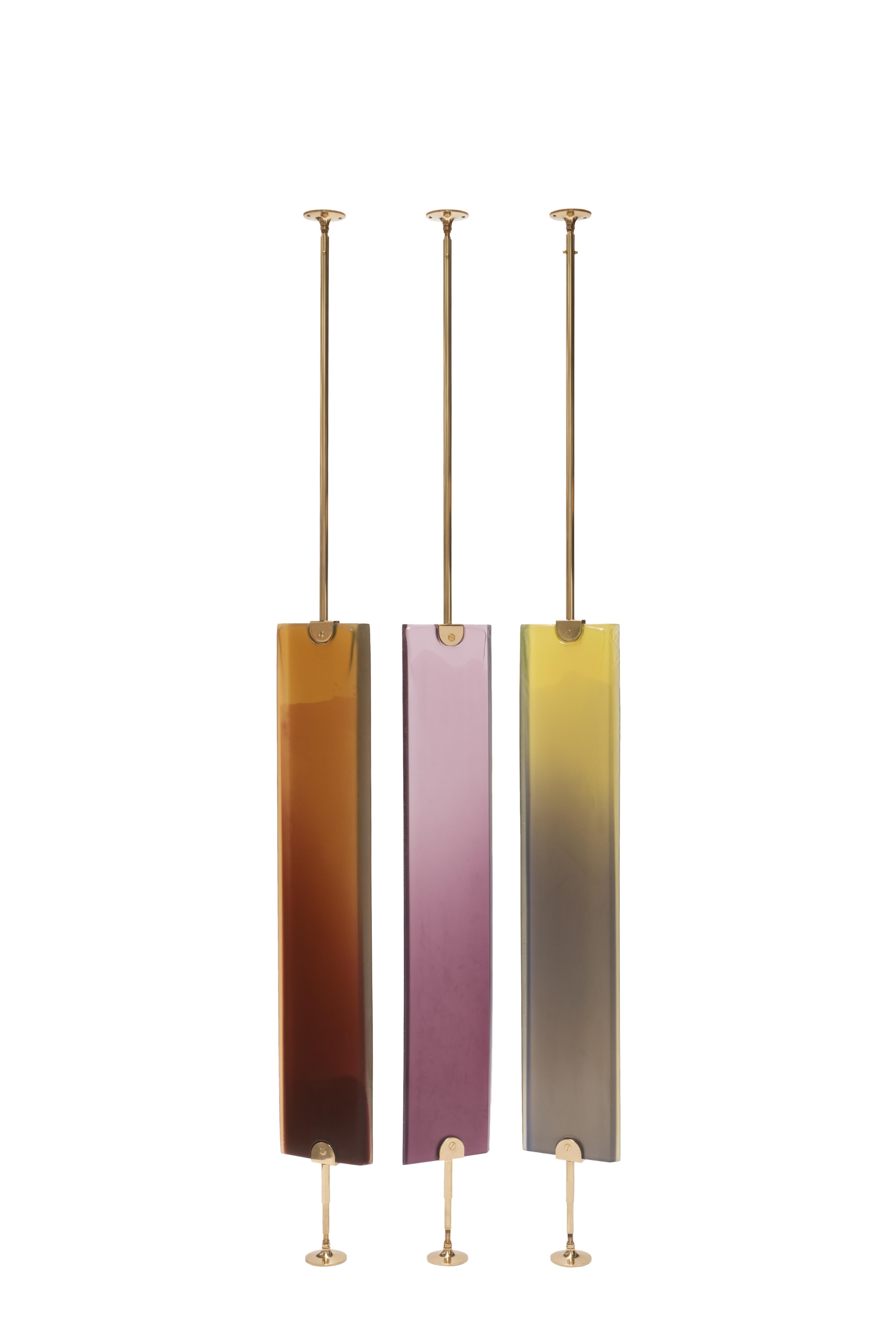 Exploring transparency in epoxy resin, Reverso is a dual-facing room divider that adds a colored veil to the surrounding space. The soft, shaded nuances are achieved through a handcrafted resin-casting technique, carried out entirely by skilled