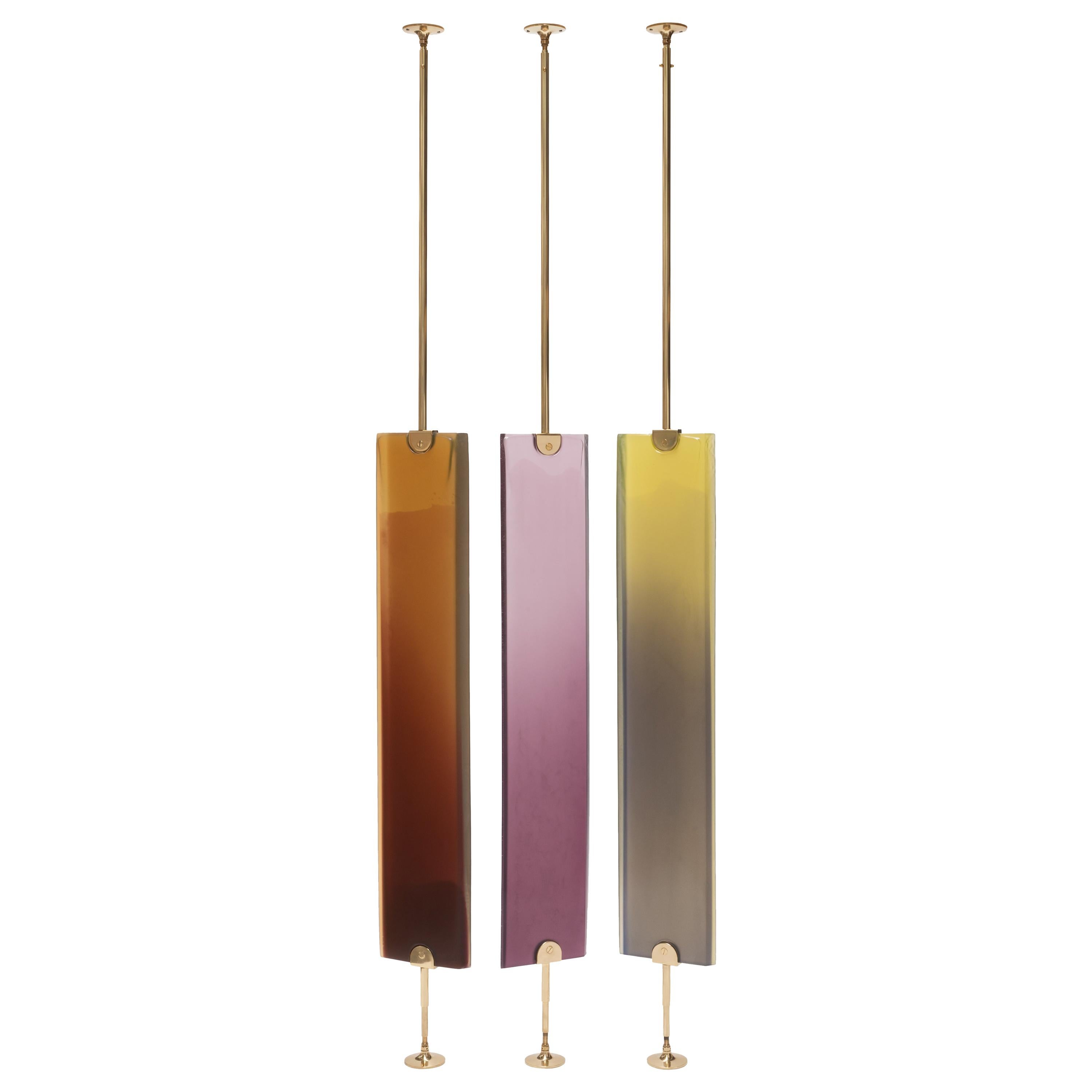 Transparency Matters collection by Draga & Aurel:

Partition screen made from cast resin and self-standing structure in polished brass. Transparency of the resin creates light effects and color nuances.
Handcrafted in our Atelier in Como. Each piece